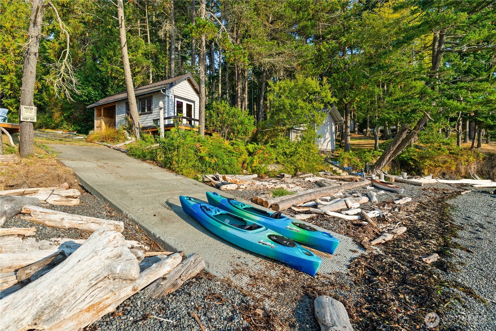 Private boat launch with boat house in background.