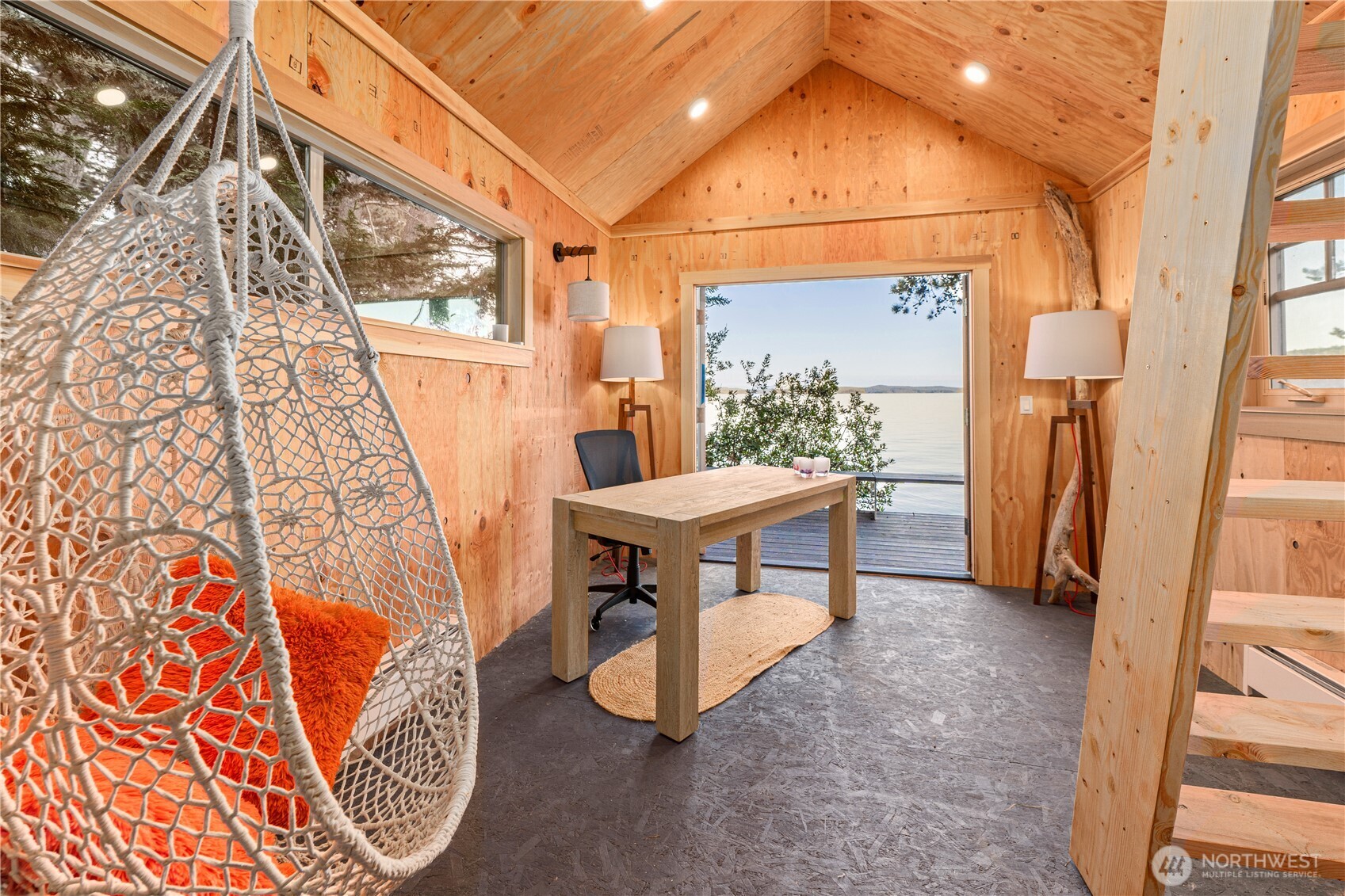 Boat house features a loft bed, deck overhangs beach, composting toilet and outdoor shower ready for installation. Dry and heated.