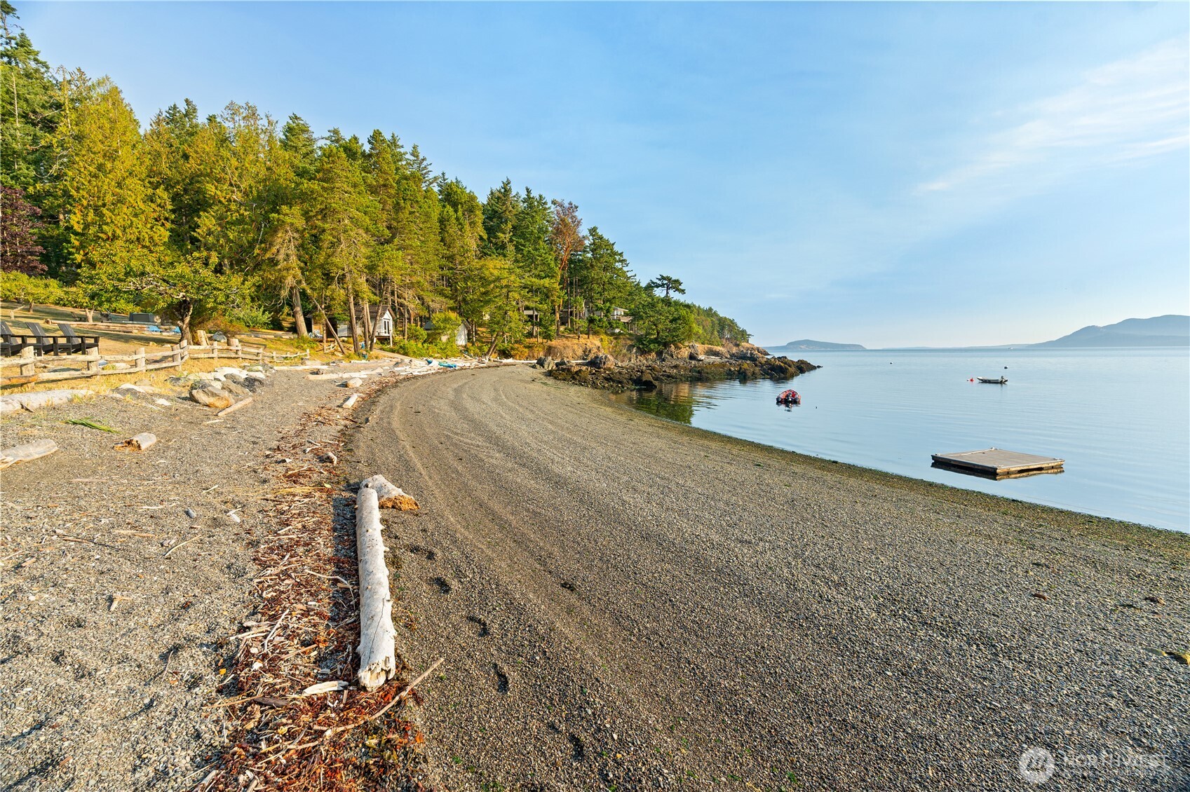 Beach at low tide. The tide swing is typically 2ft to 8ft.  Approximately 330 lineal feet of pebble beach offers gentle landings for boats, paddle boards, kayaks and swimmers.