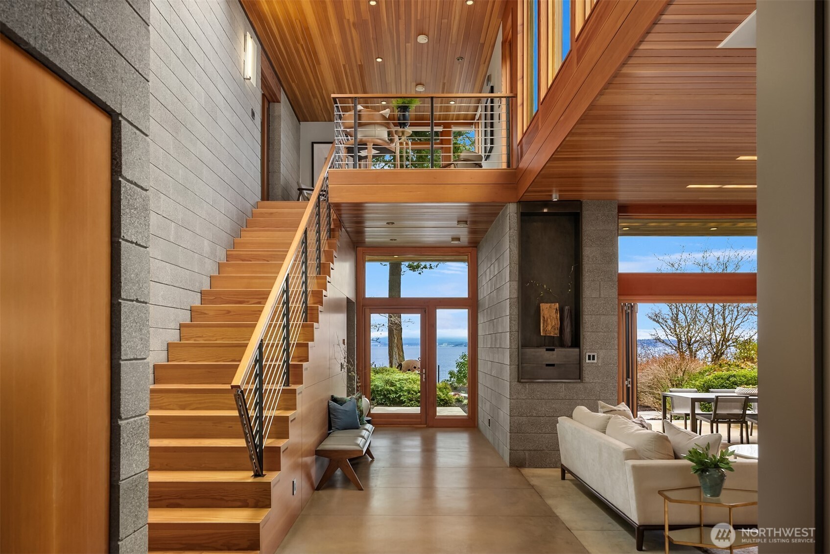 Stunning waterside of the home with covered patio