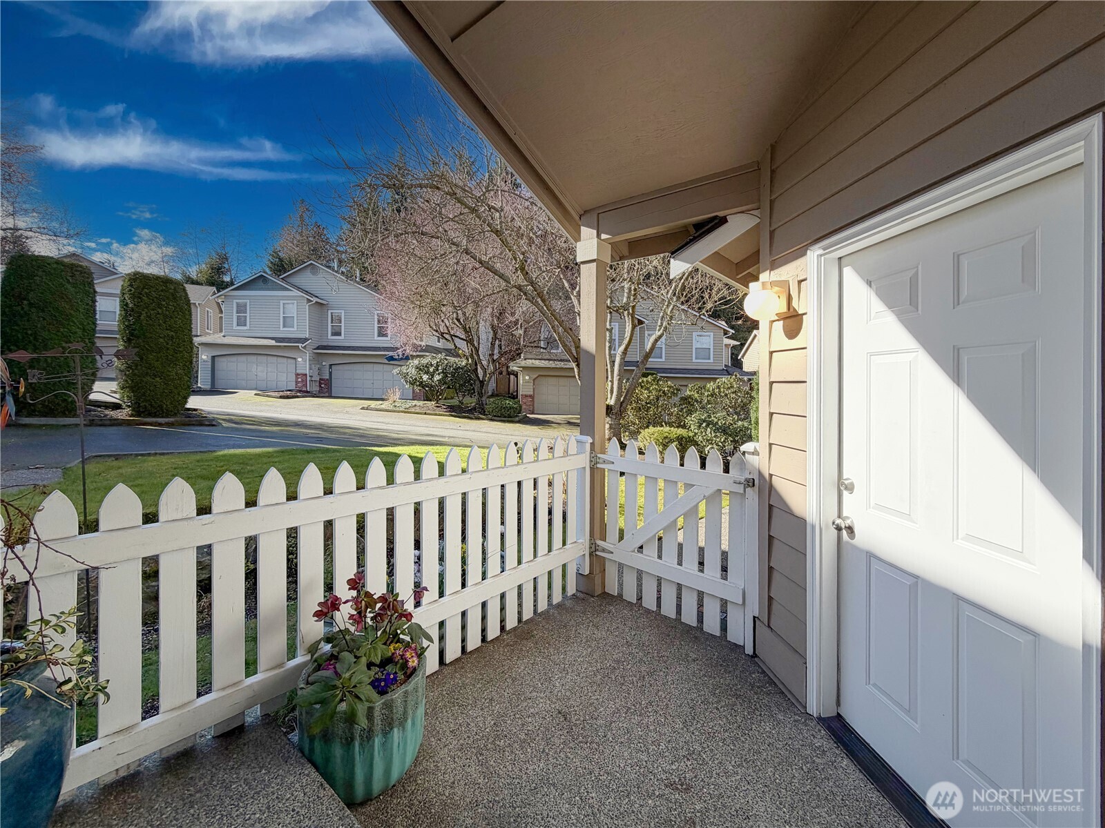 Picket-fence dreams with your private front porch area and  door leading to the 2-car garage