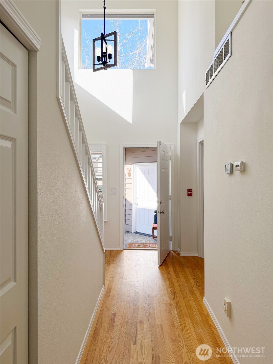 Grand sunny entry with beautiful wood floors.