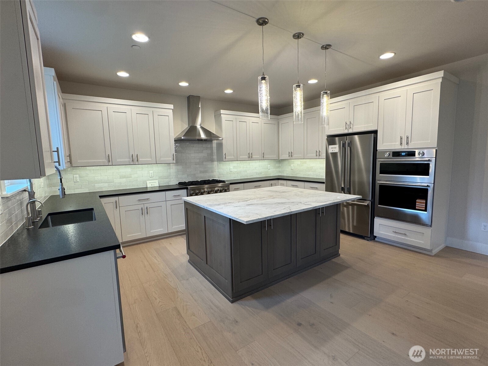 Abundant custom cabinets.   Perimeter counters have a unique leather textured quartz counters.