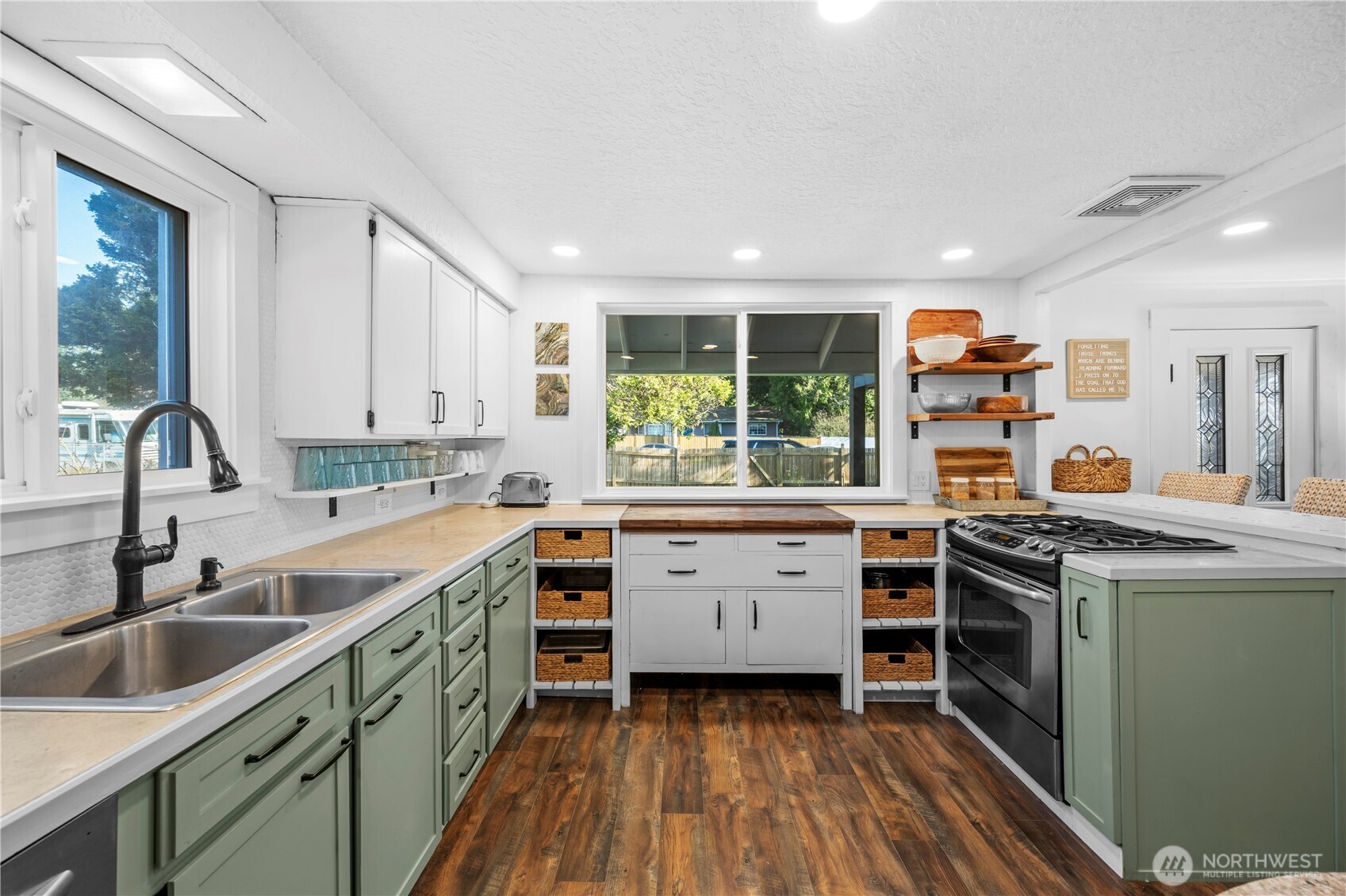 Warm butcher block counter and charming open shelving make this kitchen both functional and full of character.