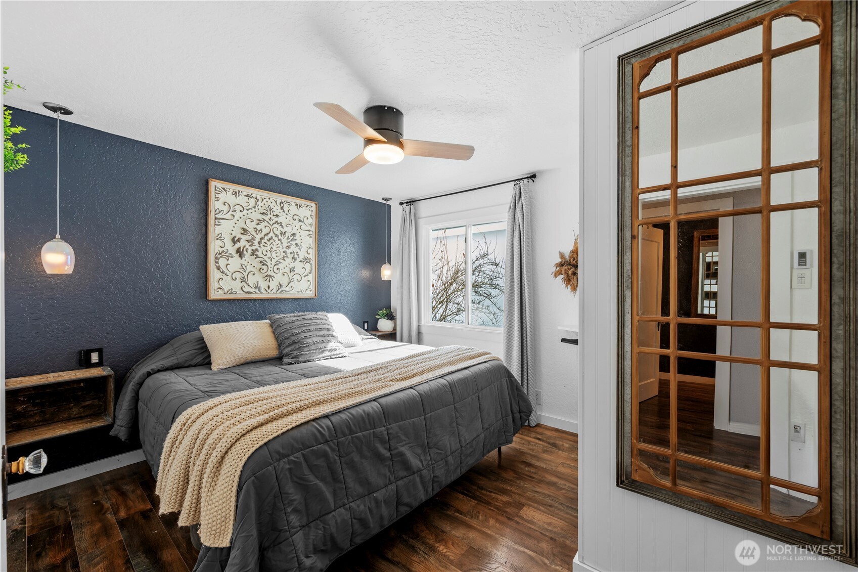 Comfortable primary bedroom featuring a walk-in closet and private half bath.