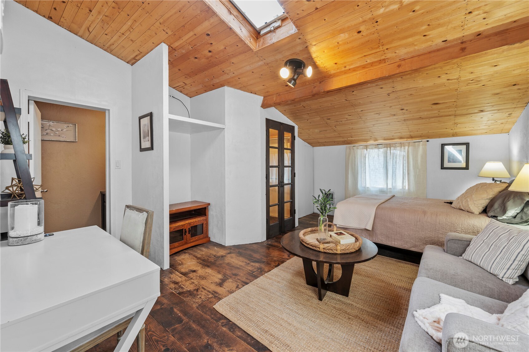 Vaulted wood ceilings with exposed beams create an inviting space.
