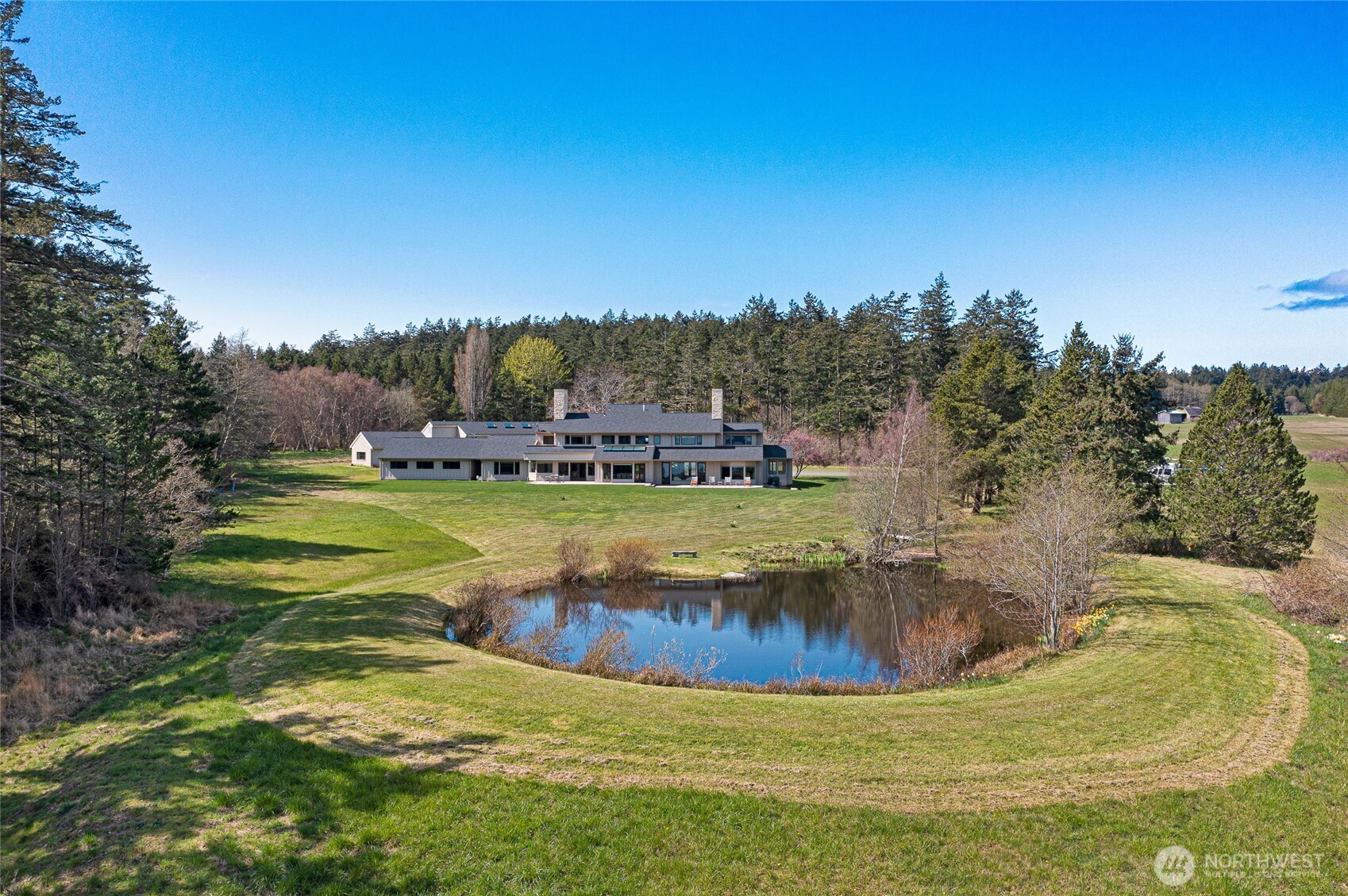 The two-level 6-bedroom residence overlooks tranquil ponds and open pastures, offering refined indoor-outdoor living in a private 63± acre setting.