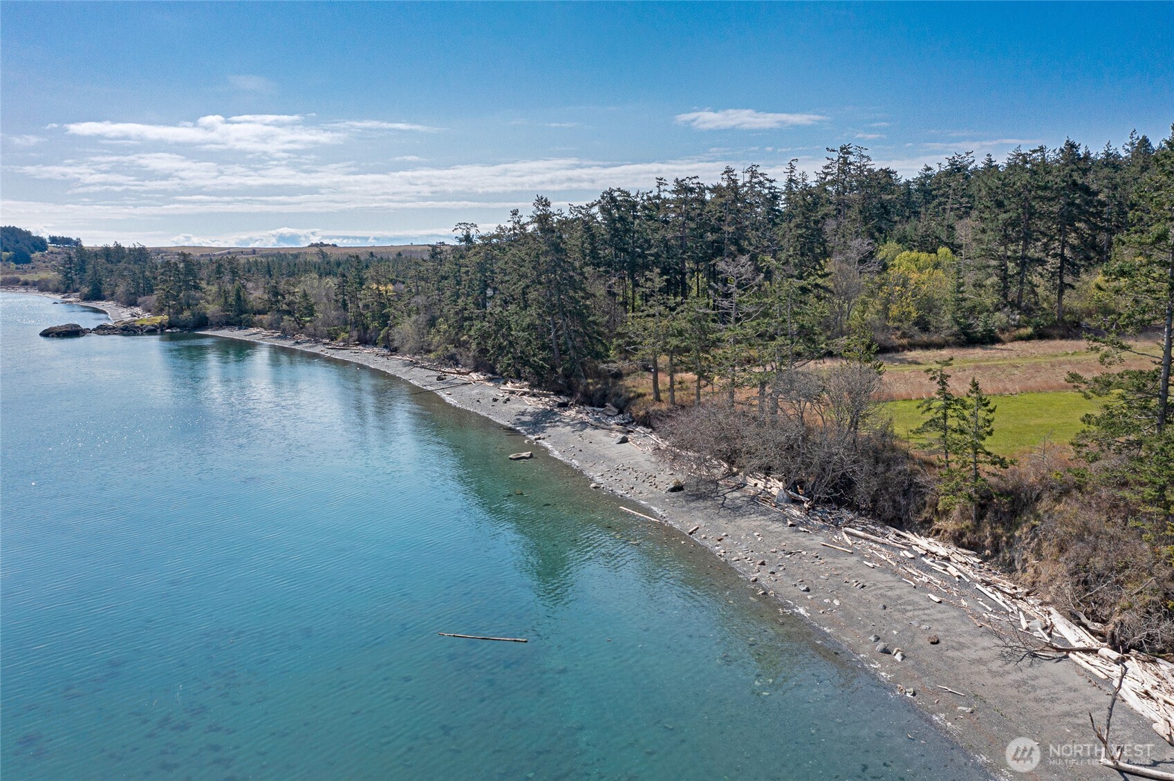 Coveted 515± ft of low-bank shoreline with easy beach access and panoramic views across the San Juan Channel toward Mount Baker and the North Cascades.