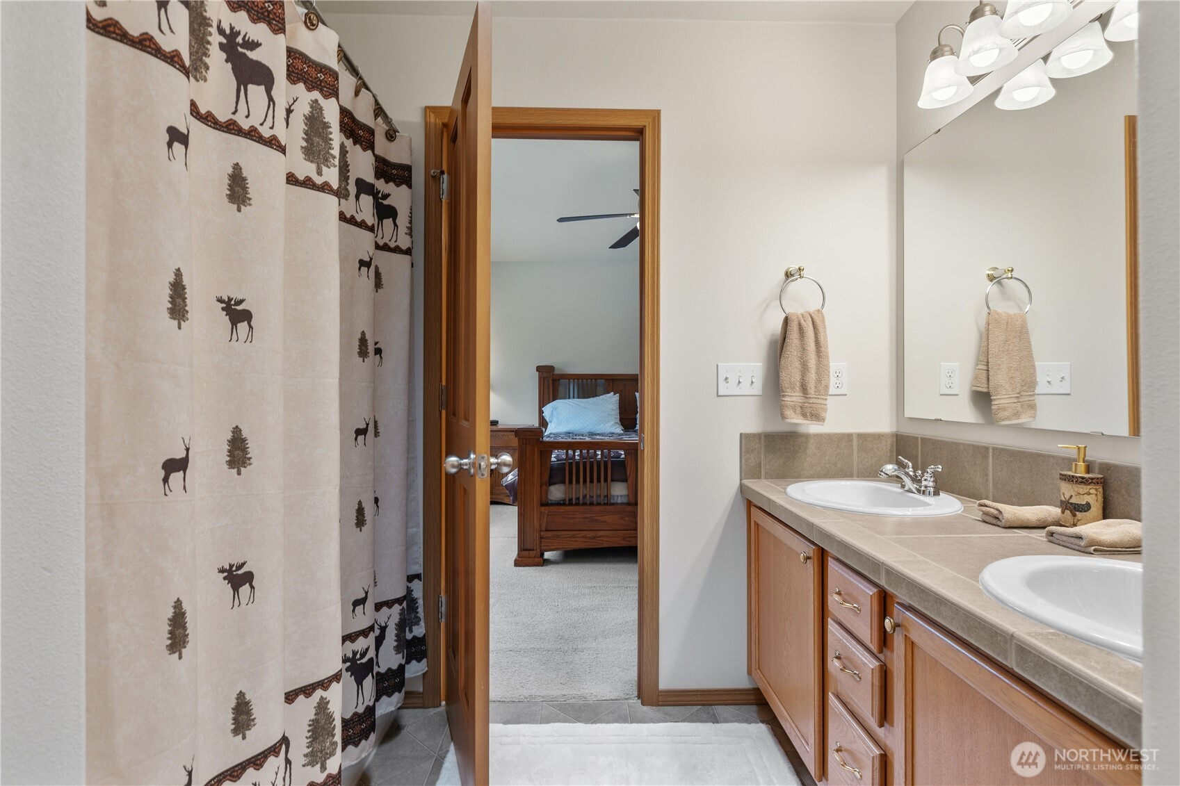 Large primary bath features a bathtub & double sinks!