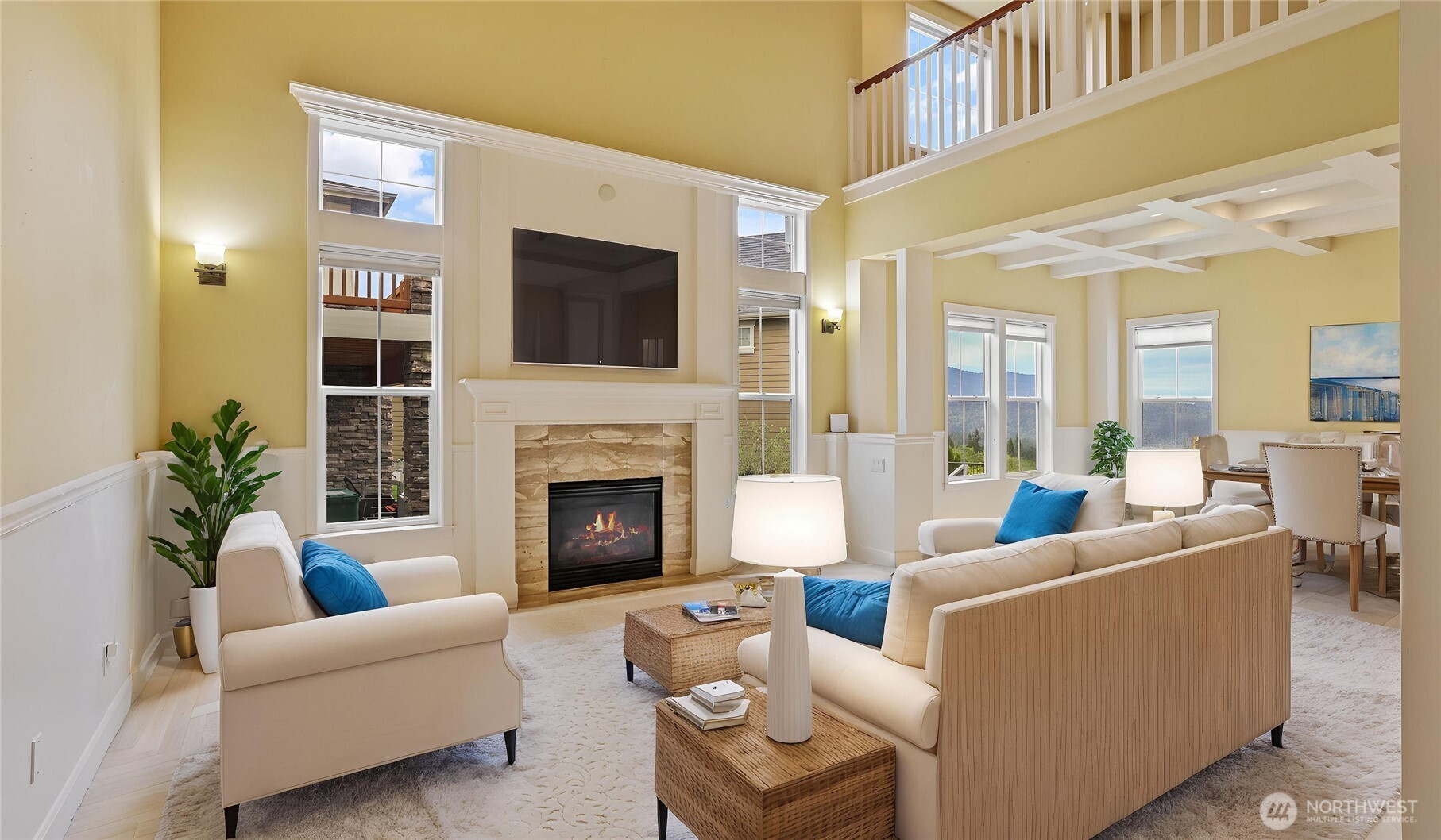 Formal living room with sky-high ceilings, wainscoting, ceiling fan and a statement fireplace centerpiece*Virtually Staged*