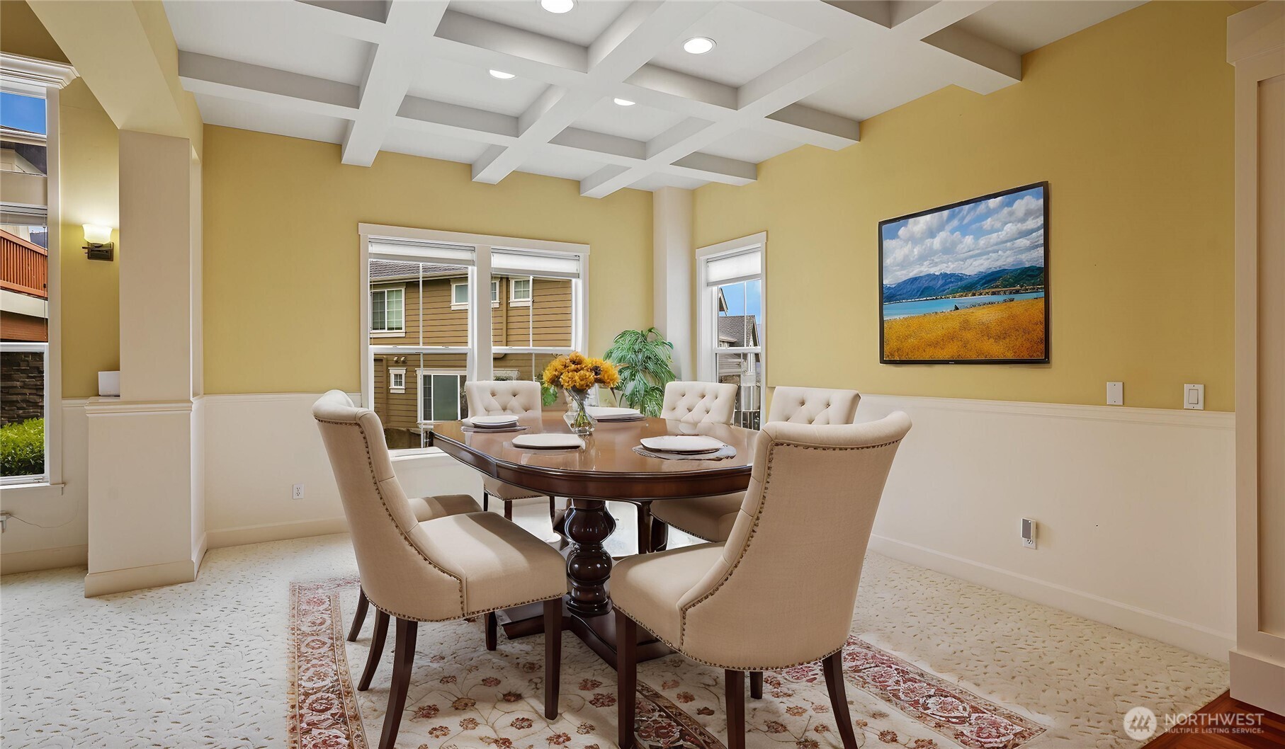 Sophisticated formal dining room adorned with beautifully crafted beam box ceilings that exude timeless charm. *Virtually Staged*