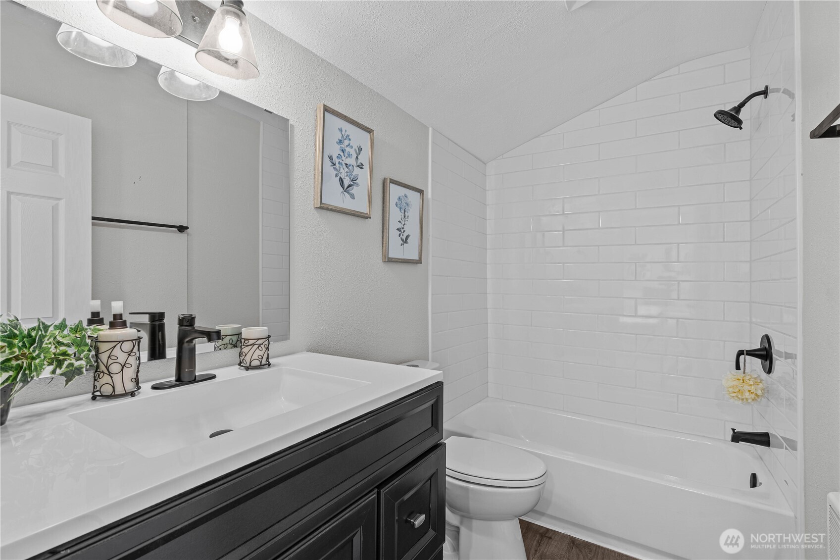 En Suite Full Bath w/Custom Tiled Shower, New Vanity, Laminate Floors and fixtures.