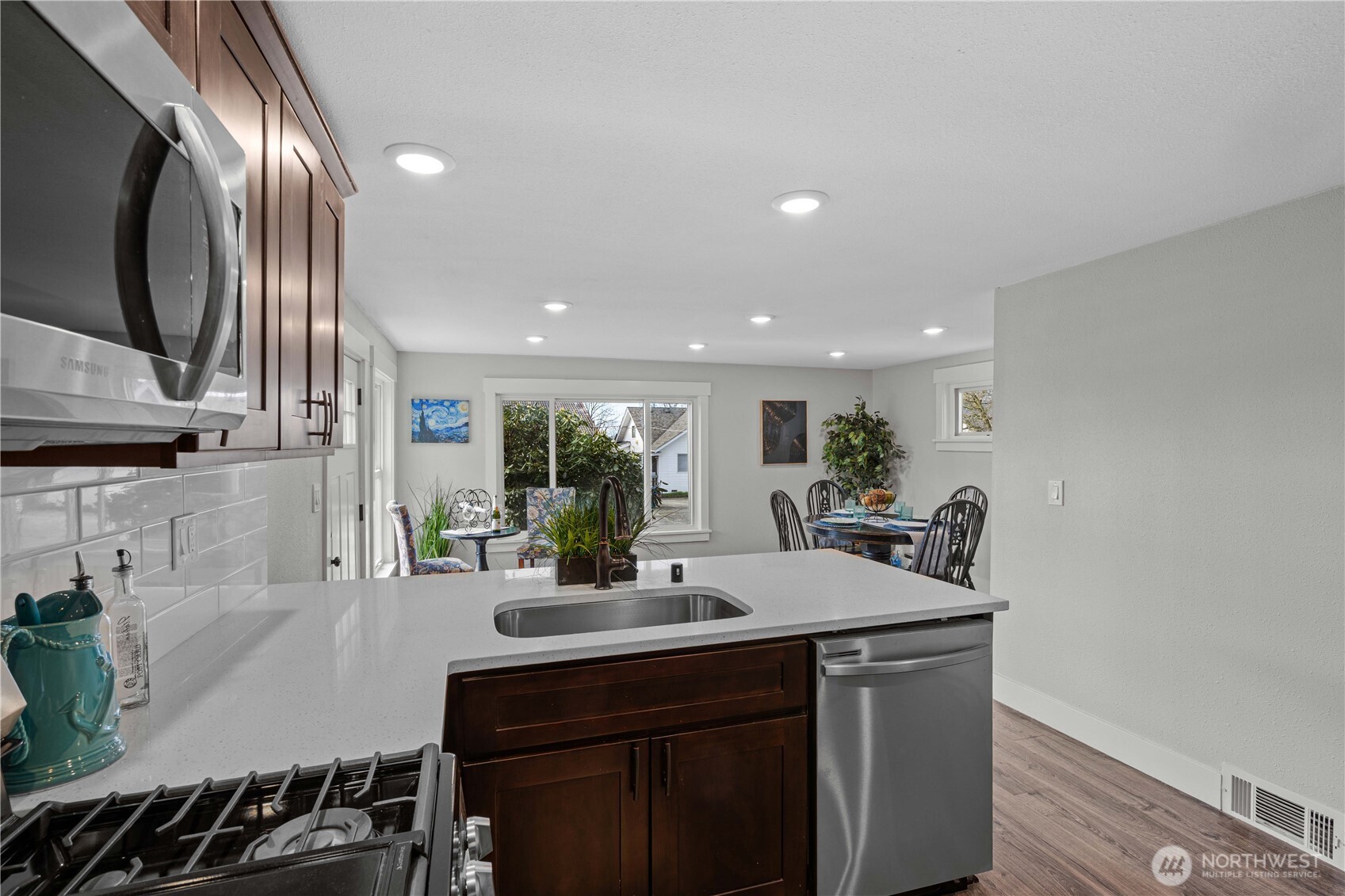 Gas Range and Overhead Microwave plus single basin stainless steel sink.