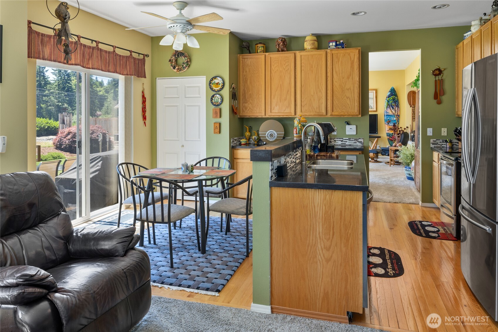 Family room looking into the kitchen with eating area, light and bright in here.