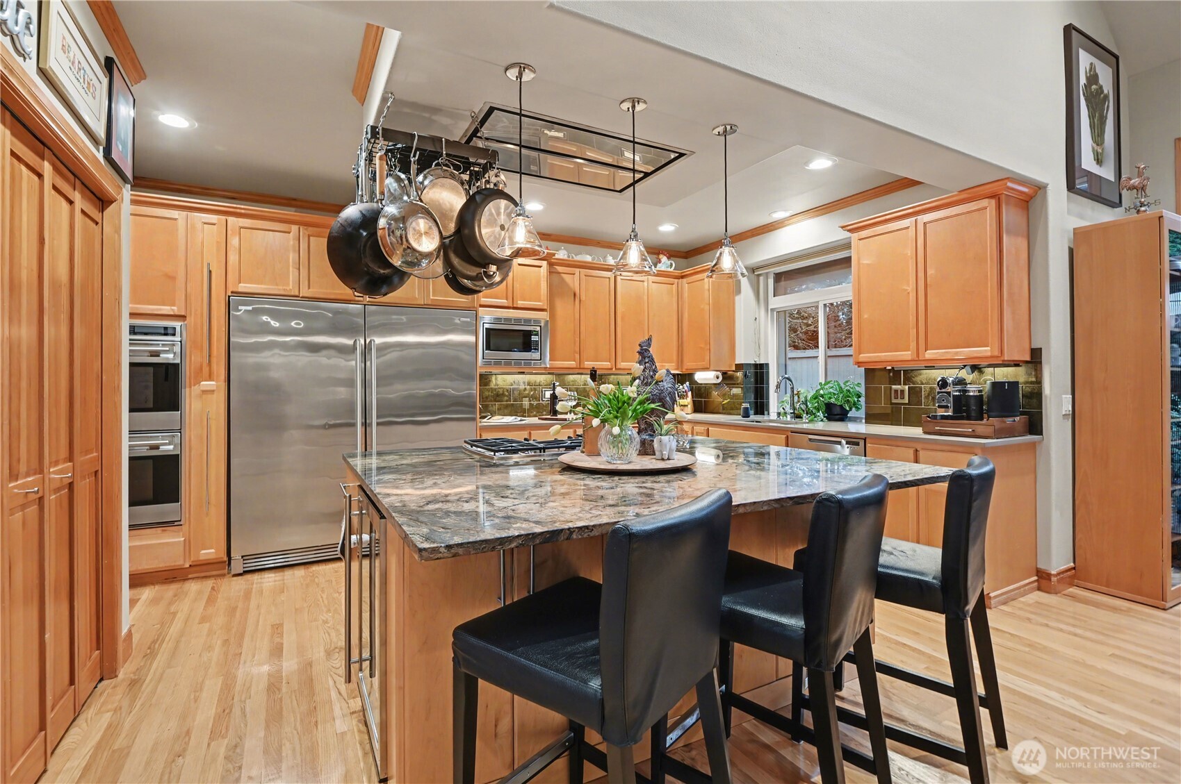Kitchen features a double oven, warming drawer, drawer dishwashers, wine fridge, & extra-large refrigerator & freezer —perfectly equipped for both everyday living & entertaining.