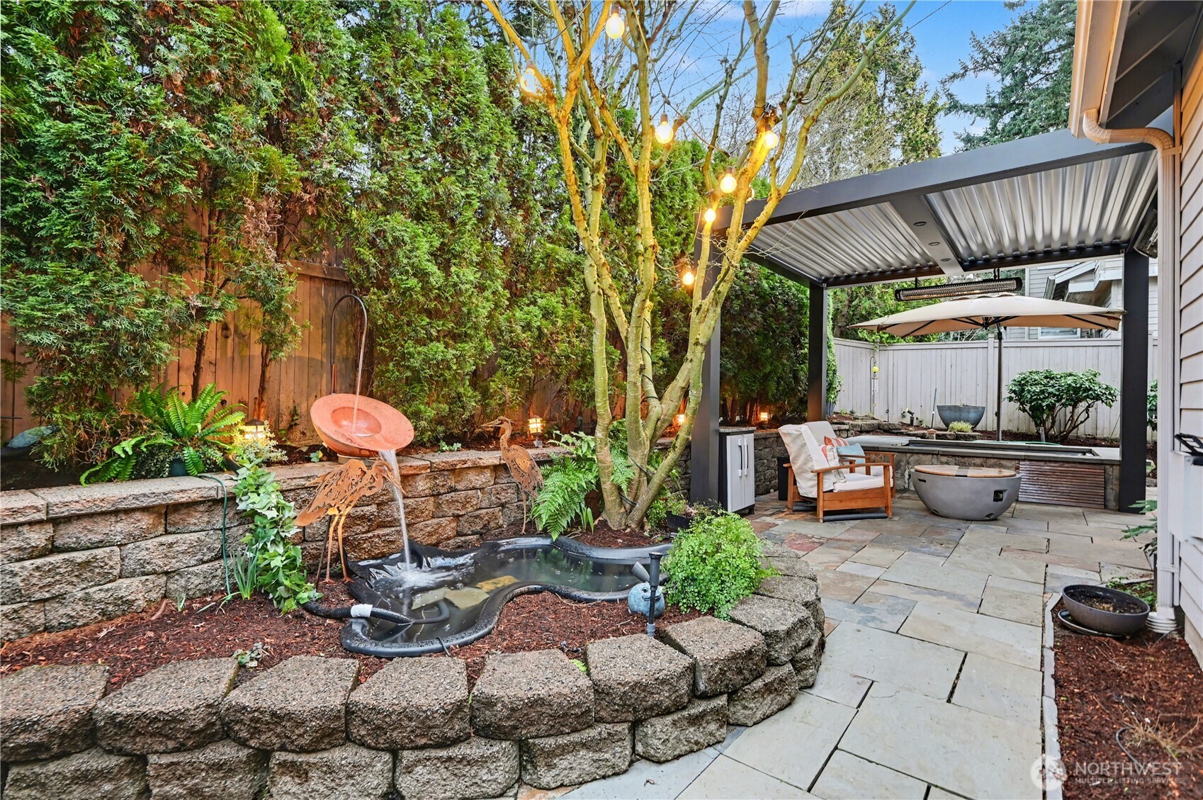 Backyard also features a charming pond surrounded by mature landscaping.