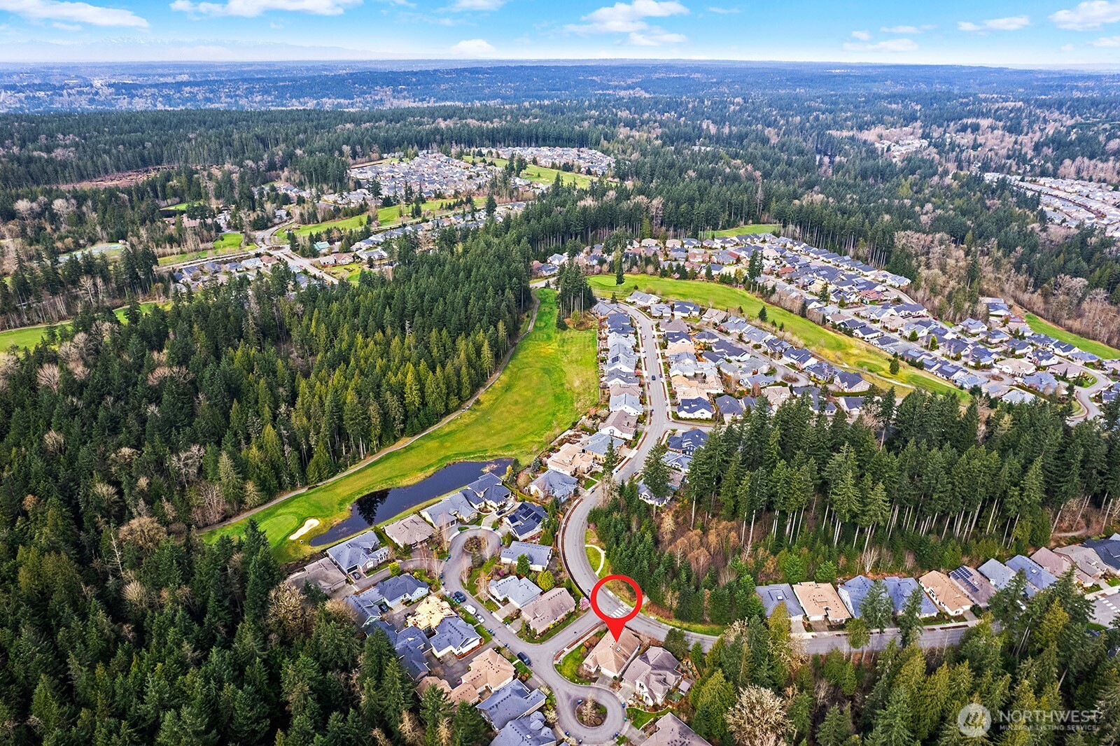 Spacious Den/Office is bright and features glass-panel French Doors plus custom built-ins and work station.