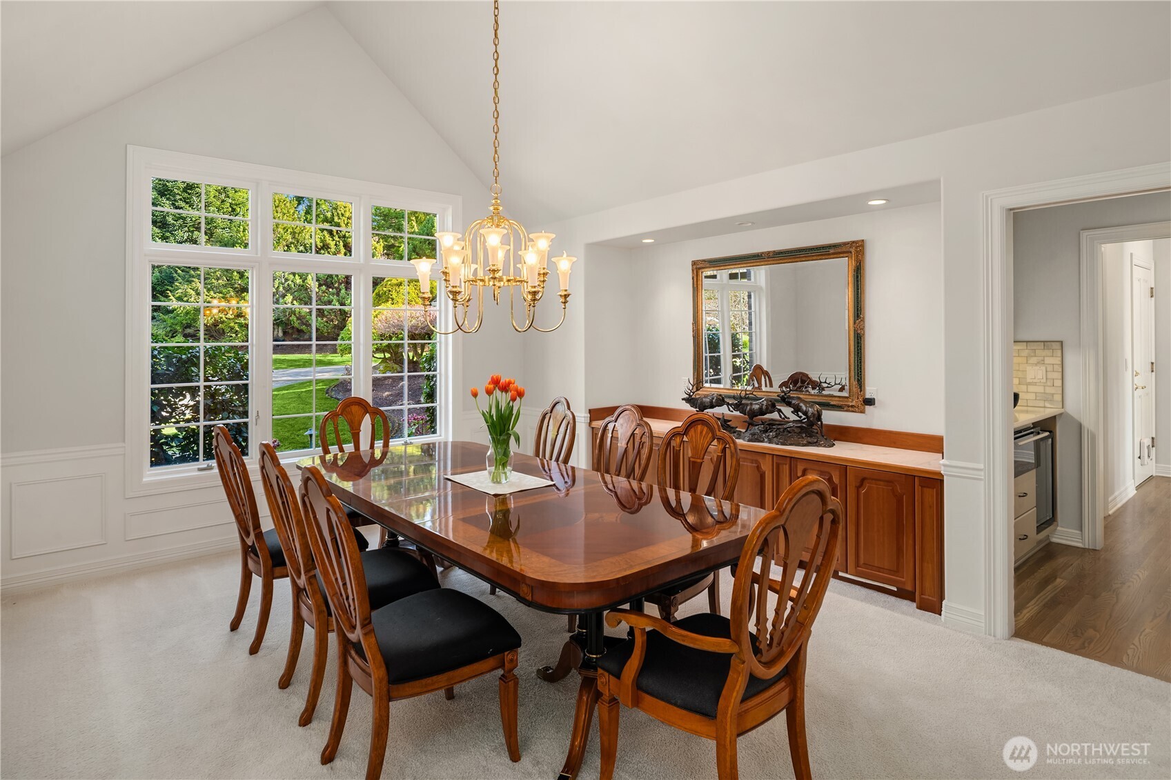 The dining room with built-in storage overlooks manicured grounds—perfect for hosting many guests.