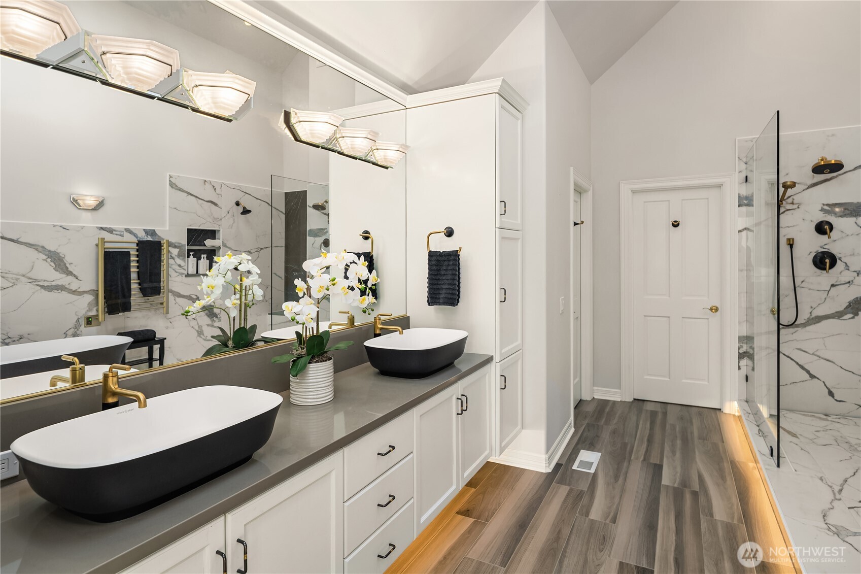 The spa bath features a large custom walk-in closet, radiant heated floors, and mood lighting.
