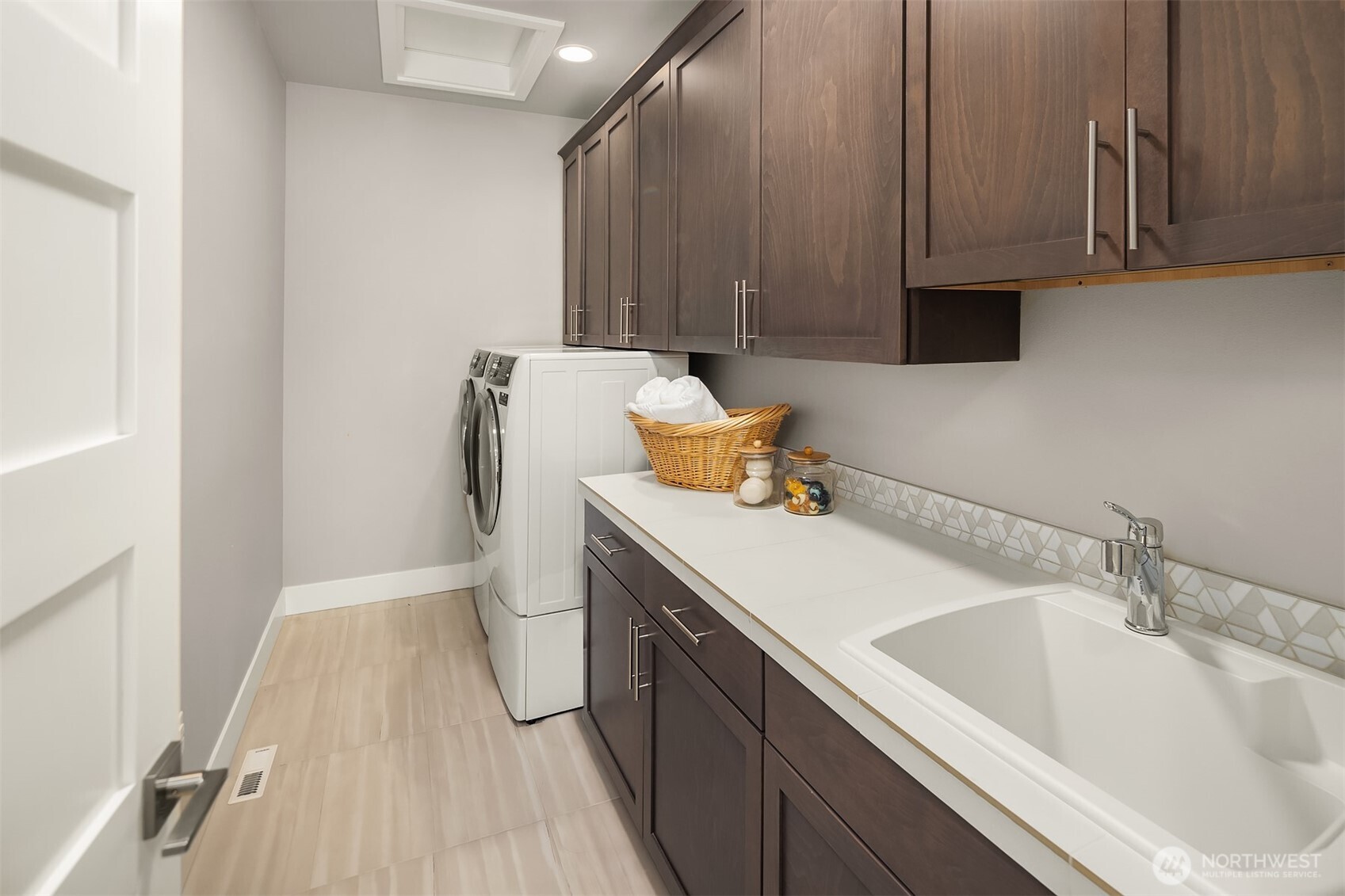 Laundry Room with sink and plenty of extra cabinets