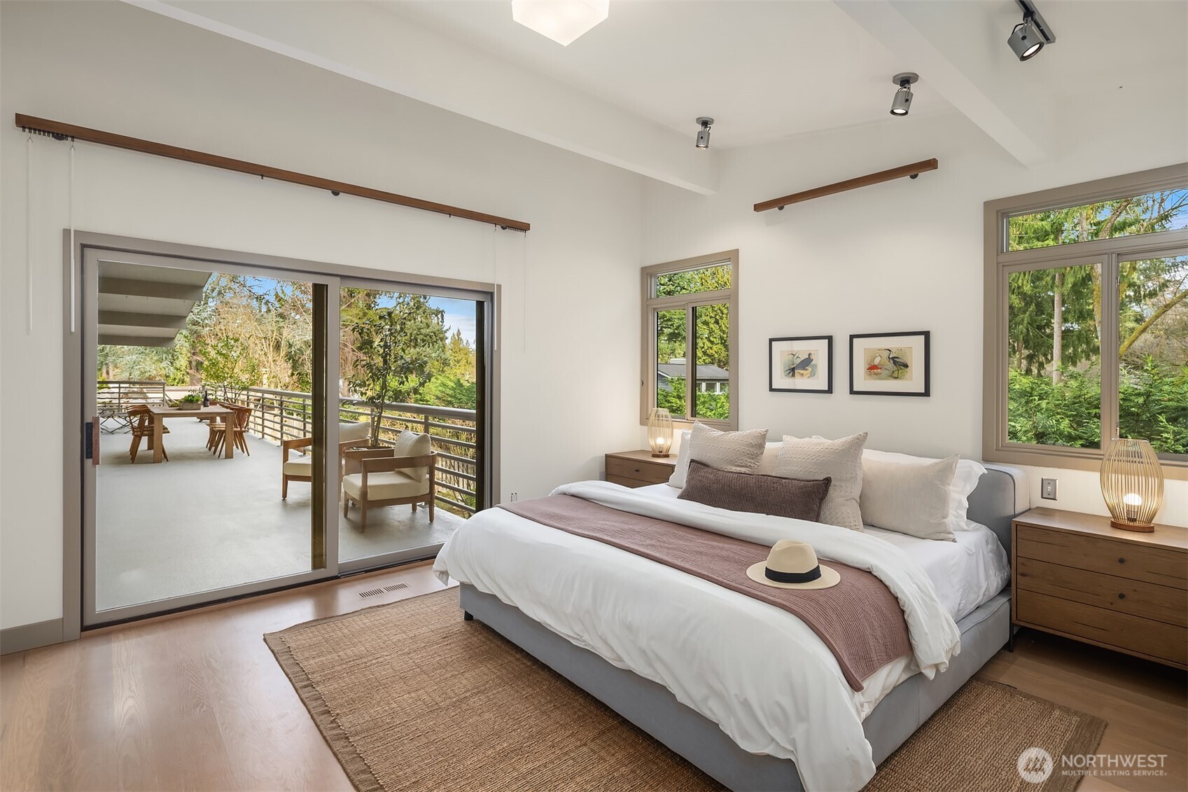 The main floor primary suite opens to the deck with beautiful garden views and sits adjacent to the library.