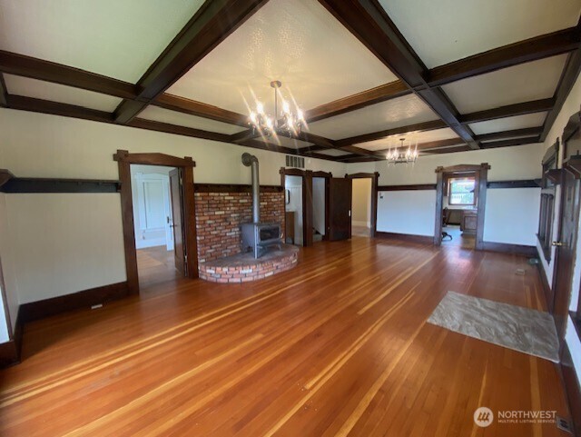 Large living room with beautiful original wood floors.
