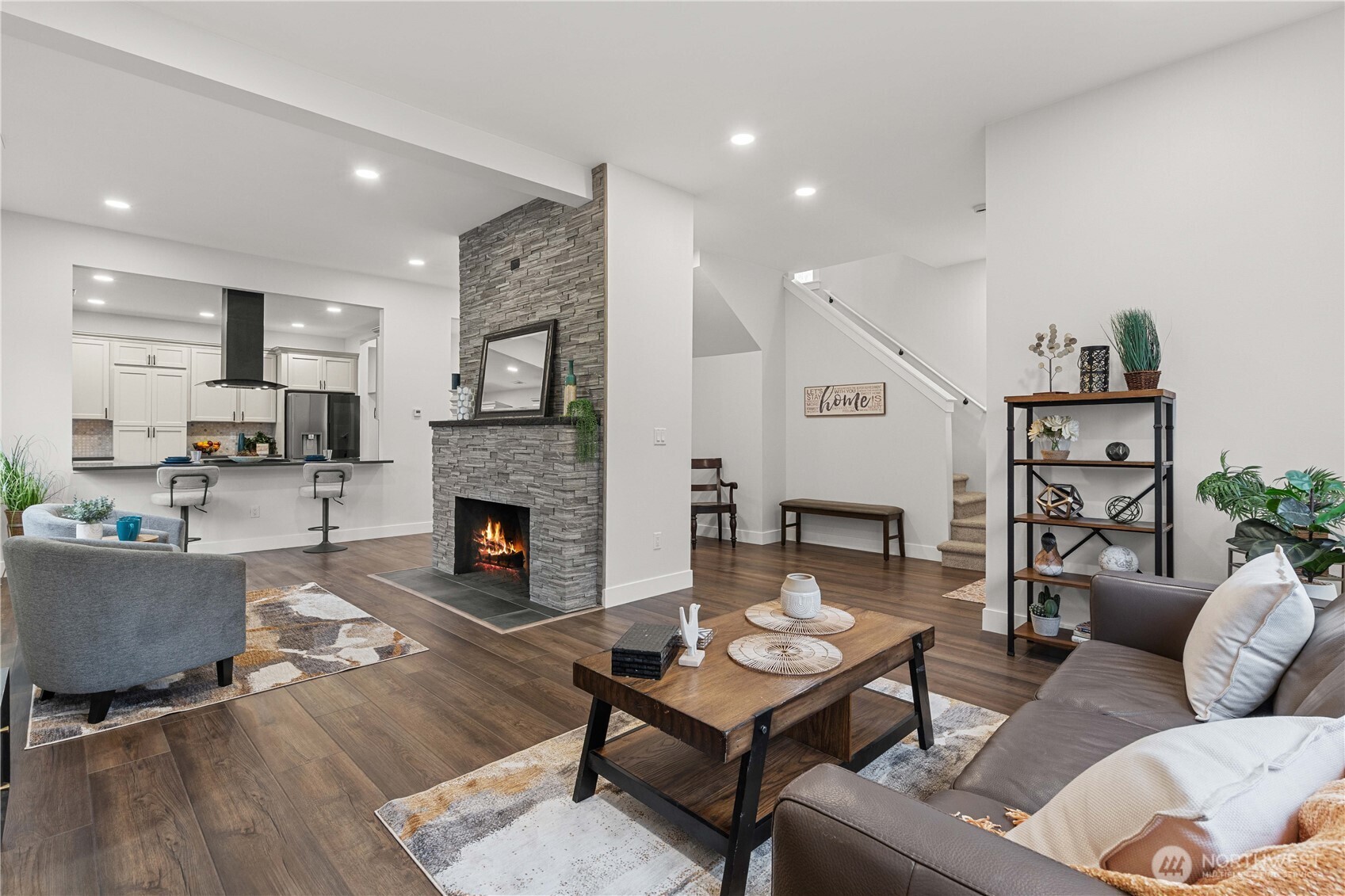 Enter the Main Floor off N 9th into the Living Room w/Floor to Ceiling Stacked Stone Wood-Burning Fireplace is Open to the Kitchen. New Laminate Floors!