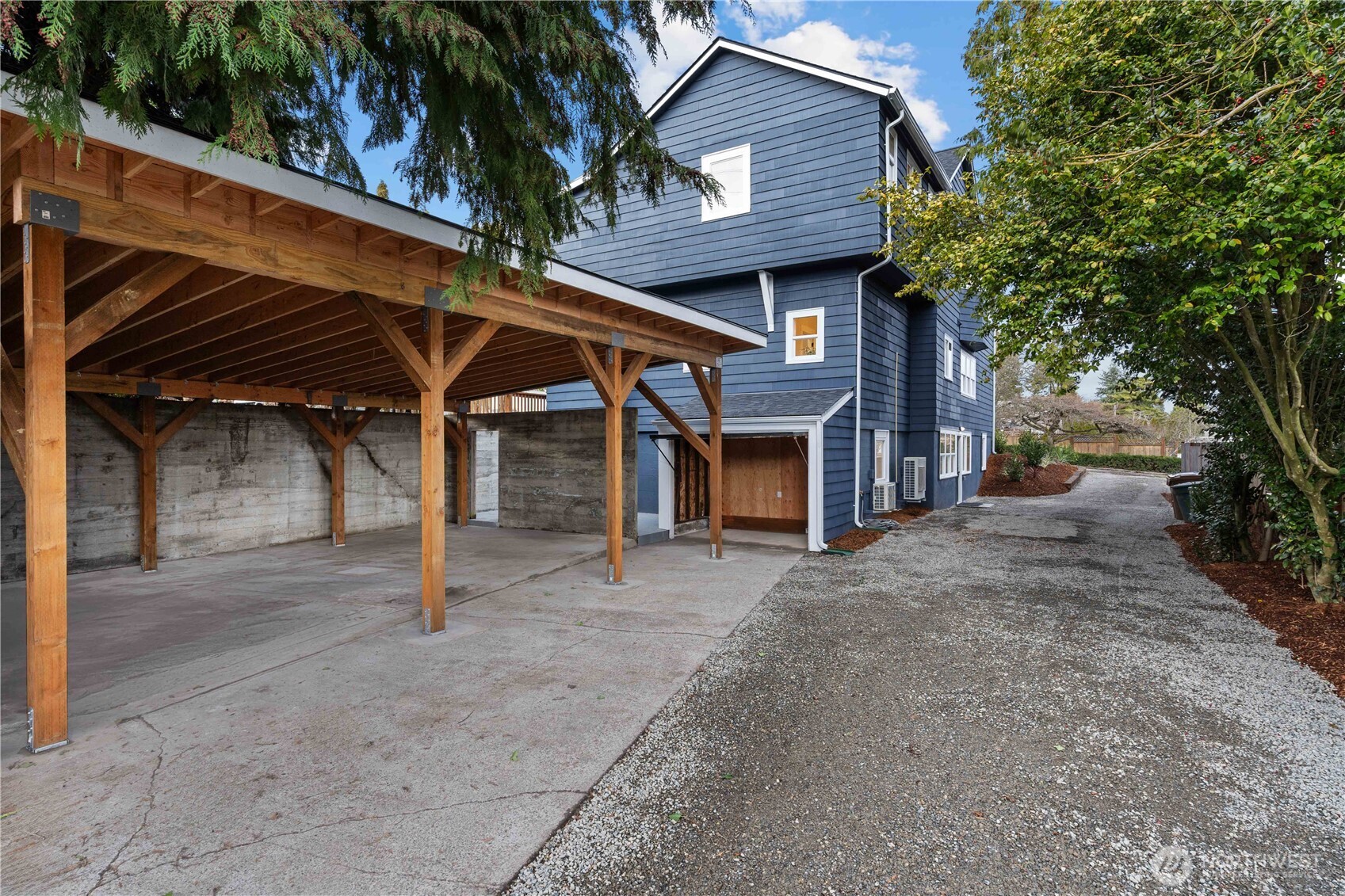 Off the Driveway is the Brand-New 3-Car Carport w/a Lawn Maintenance Garage. Perfect Spot for Mowers & Blowers! Stairs lead to the Mud Room Entry on N Lawrence and along the Driveway to the Basement Unit.