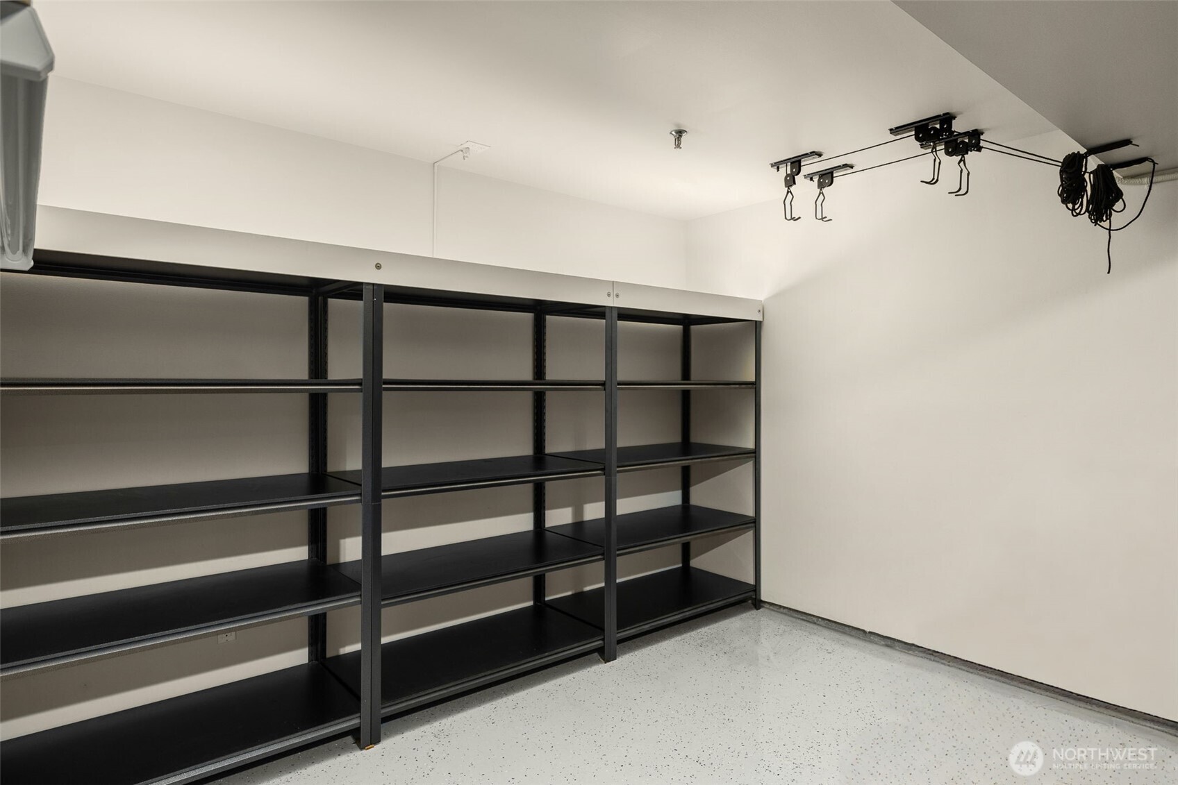 finished 2-car garage goes beyond parking—complete with epoxy floors & built-in storage