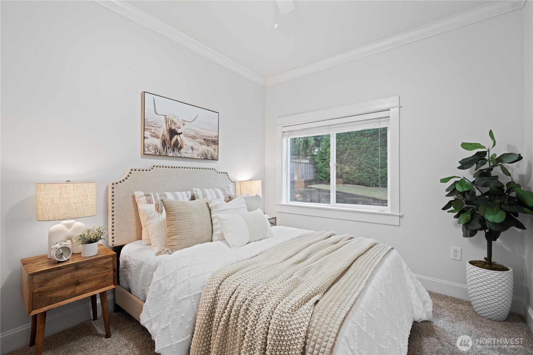 Main-floor generous primary suite with ceiling fan/light