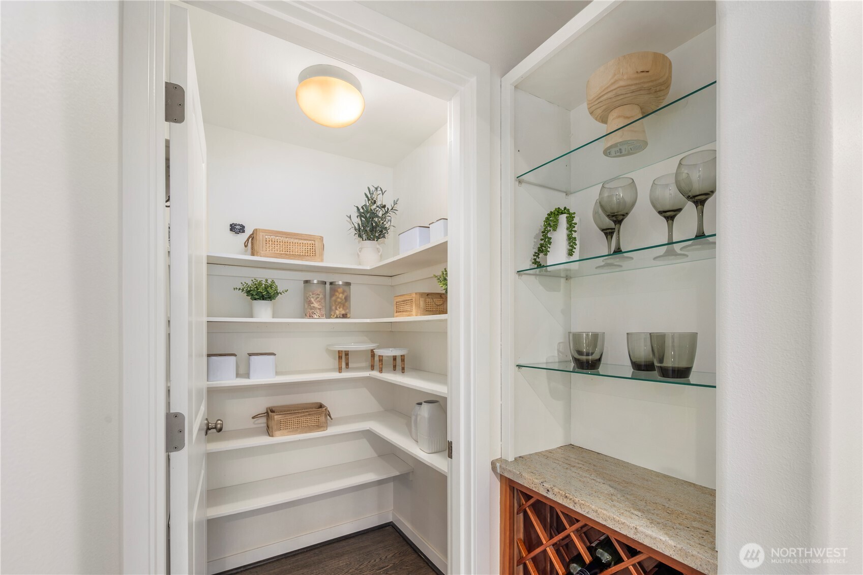 Walk-in pantry complete with generous storage and dedicated wine storage for effortless organization and entertaining.