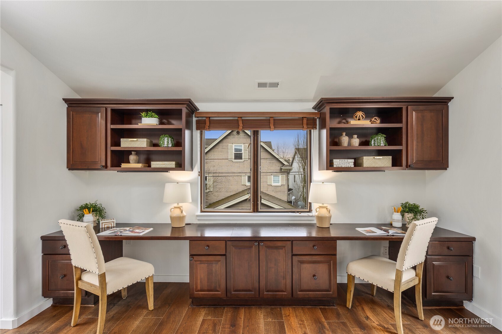 Beautifully designed home office with two Juliet balconies, built-in desks, and custom shelving, an inspiring space for working from home.