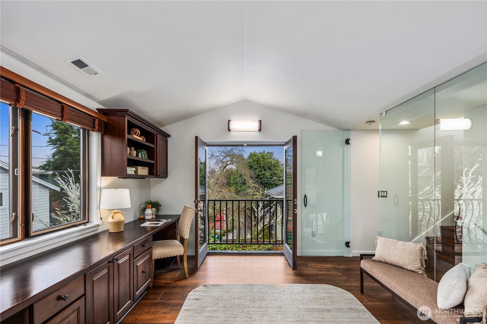 Beautifully designed home office with two Juliet balconies, built-in desks, and custom shelving, an inspiring space for working from home.