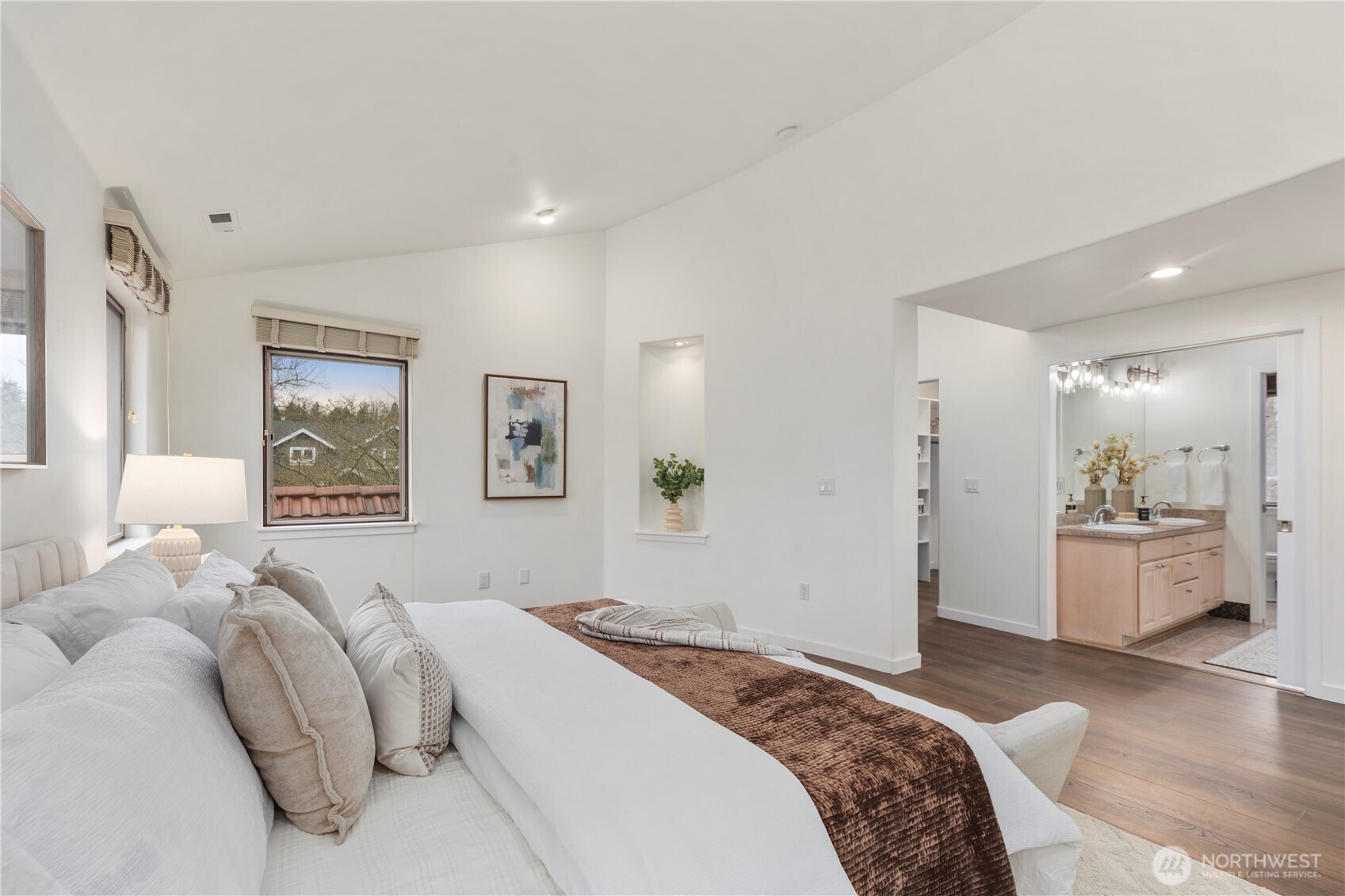 Sumptuous primary suite featuring a spacious walk-in closet and luxurious five-piece bath with soaking tub.