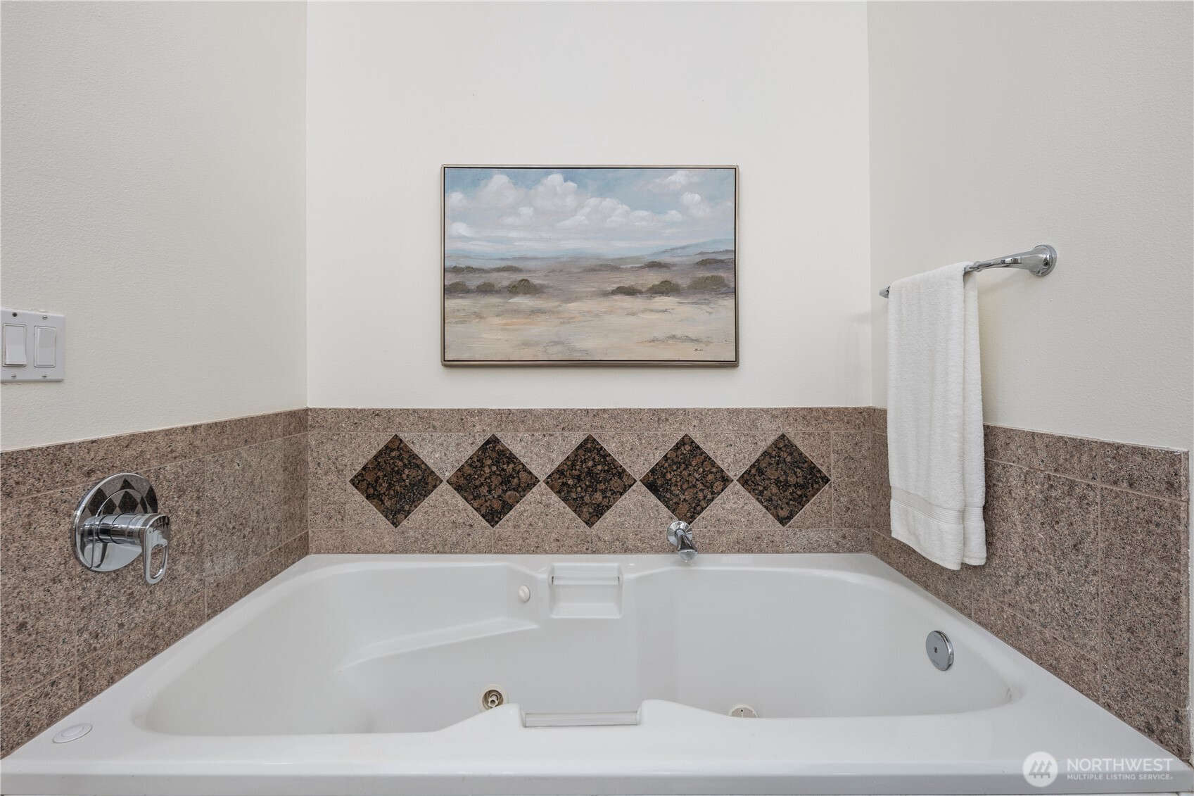 Sumptuous primary suite featuring a spacious walk-in closet and luxurious five-piece bath with soaking tub.