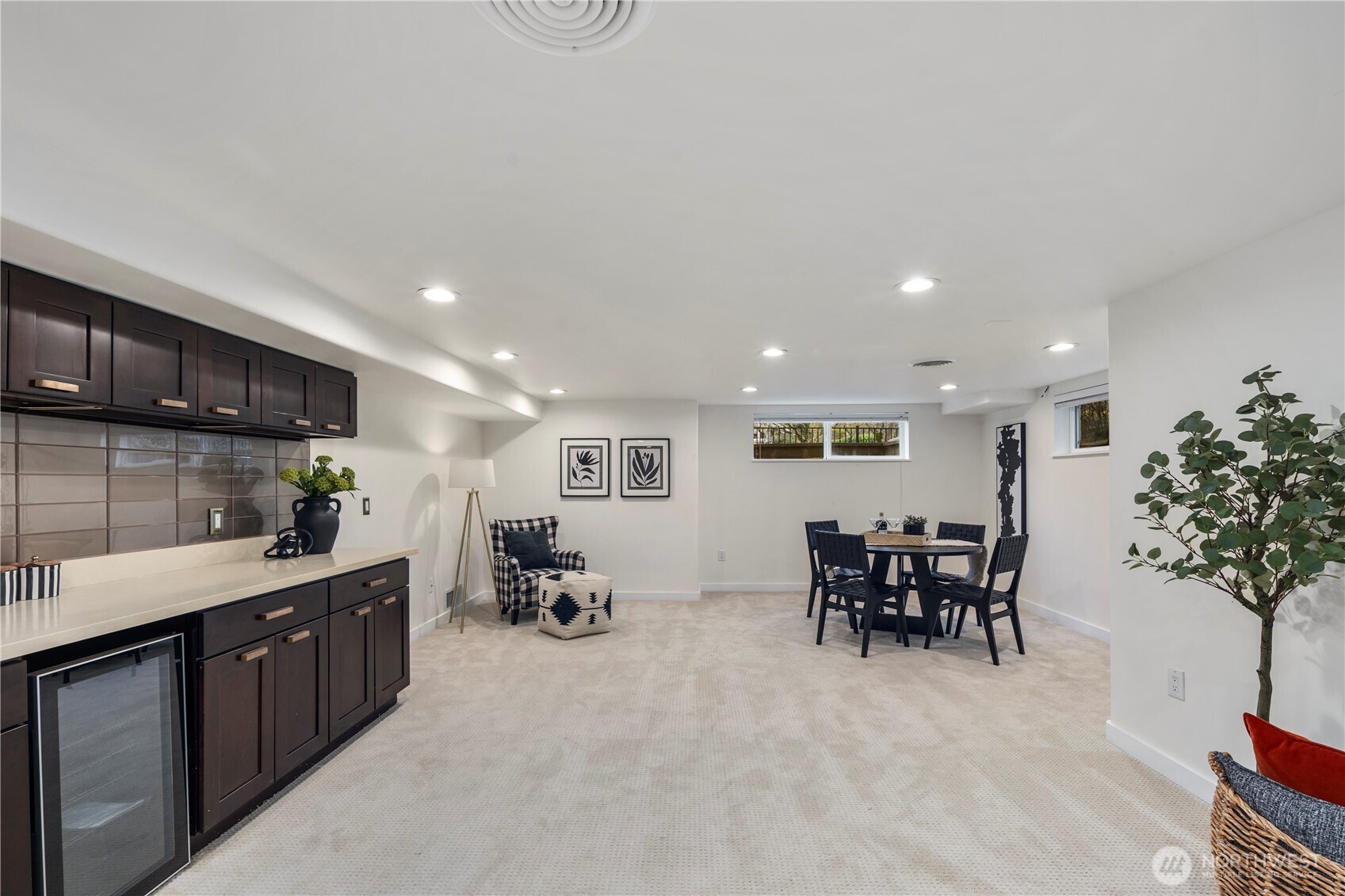 Expansive lower level offers the perfect setting for a media room, play space, or recreation area, complete with a convenient wine fridge.
