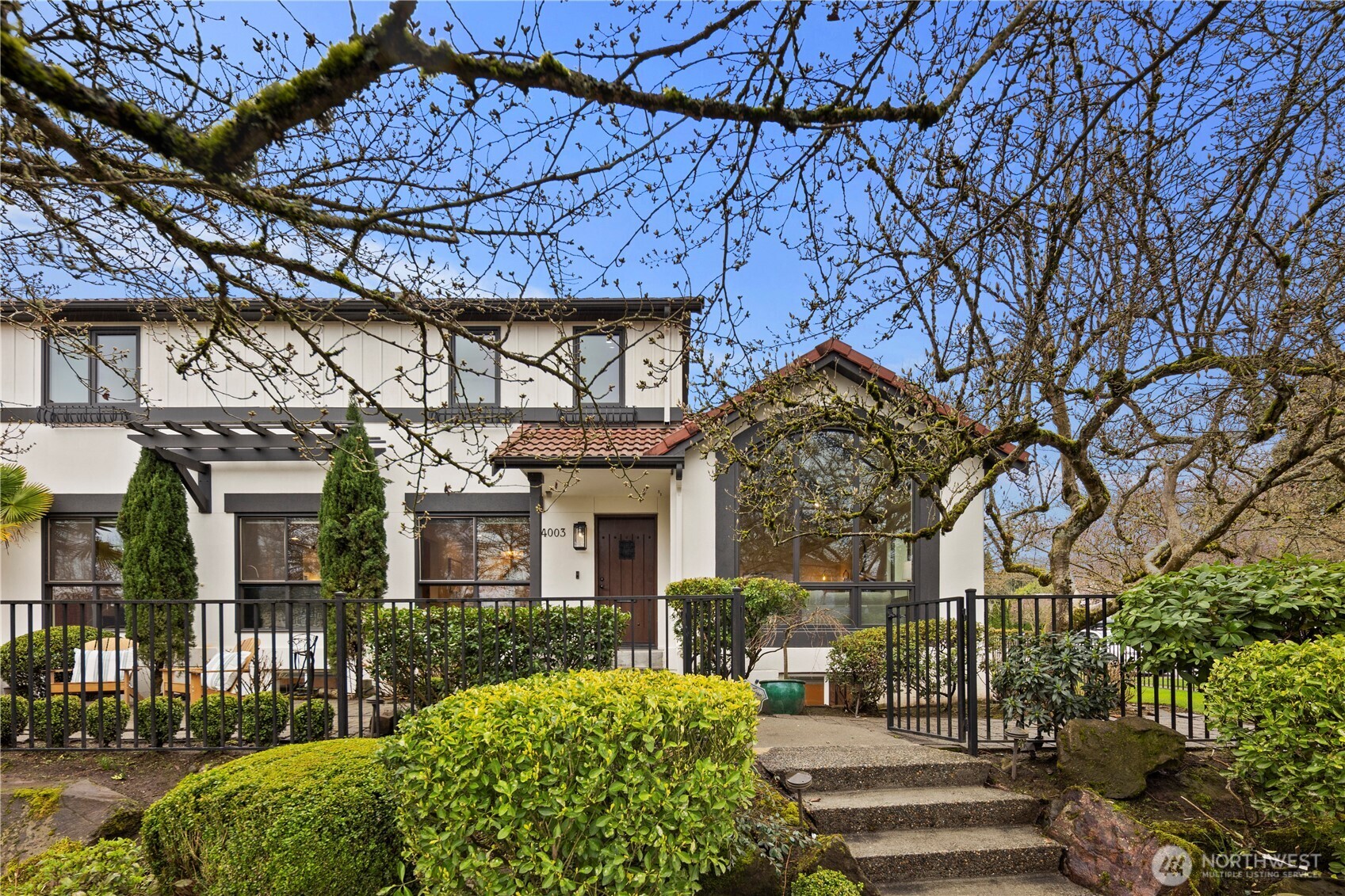 Mature magnolia trees create a stunning seasonal display and add timeless beauty to the home’s outdoor spaces.