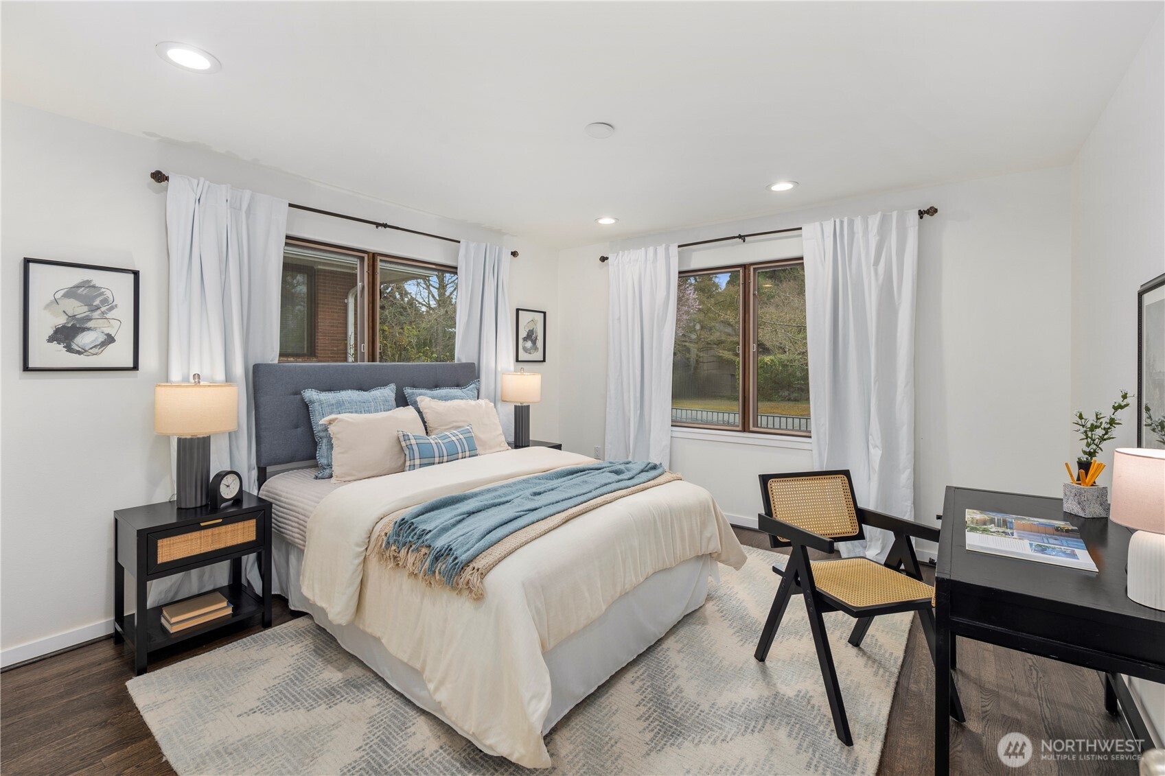 Bright and welcoming main-level guest bedroom offers abundant natural light and a comfortable retreat for visitors.