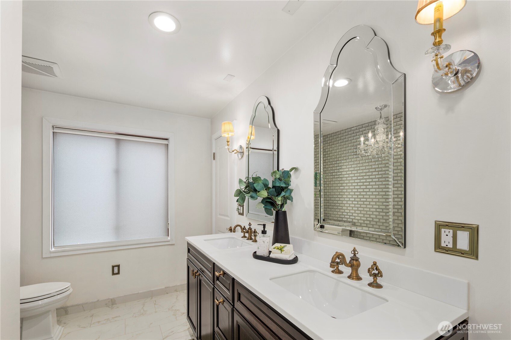 Luxurious guest bath on the main level offers a serene retreat that may make your guests never want to leave.