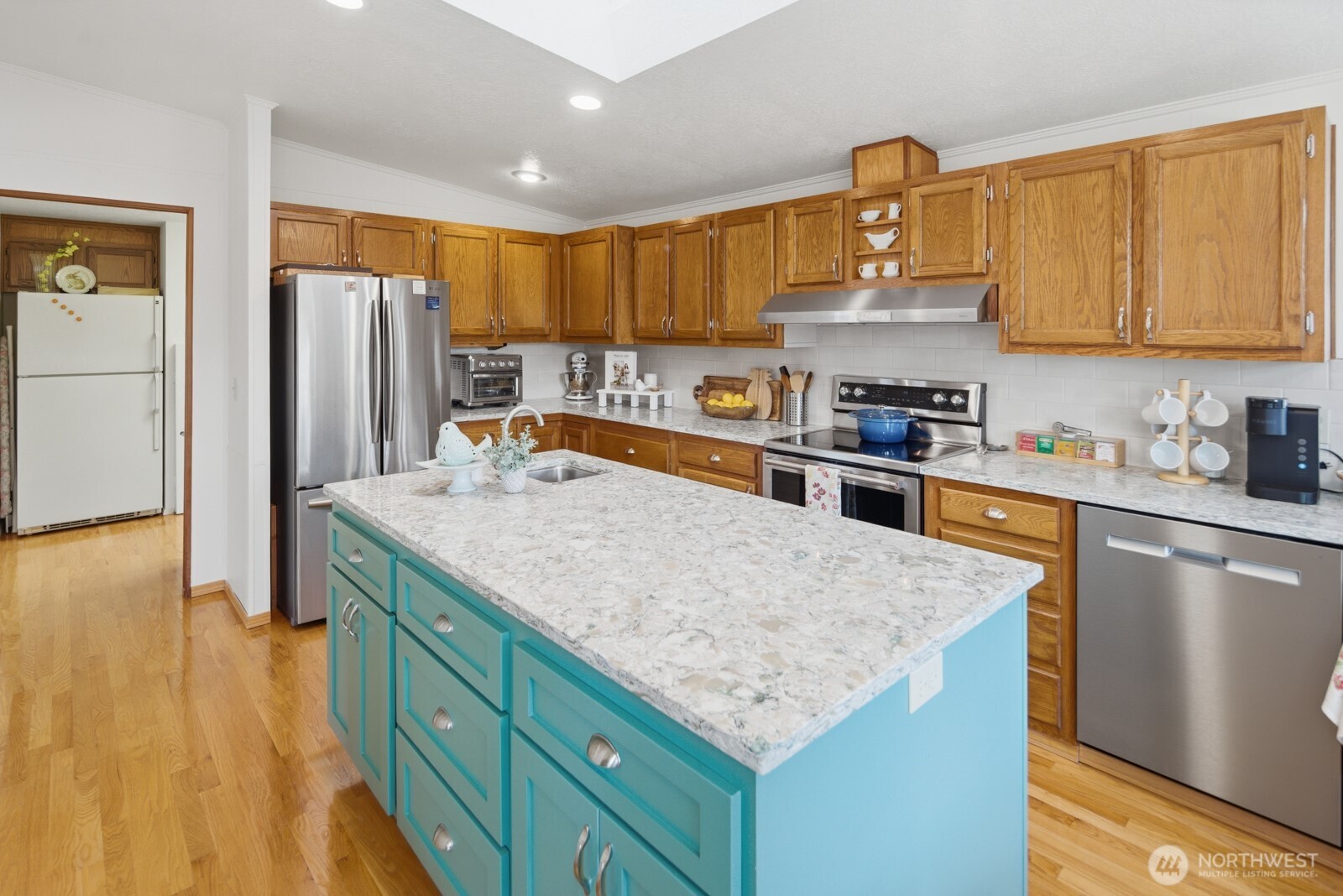 Amazing amount of natural light from skylights and large windows. (2nd refrigerator also stays with the home)