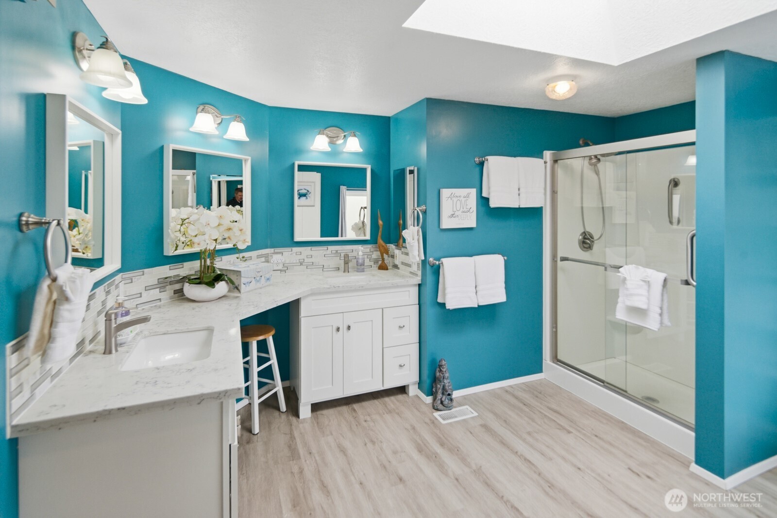 Incredible spa-like ensuite bathroom complete with dual vanity sinks, quartz countertops, a large walk-in shower, and an inviting freestanding soaking bathtub. Beautifully updated.