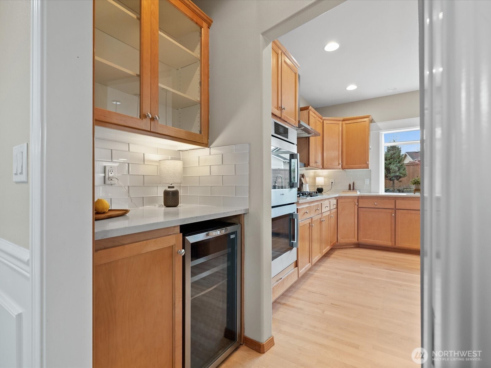 Garden window highlights view of the waterfall and private backyard.