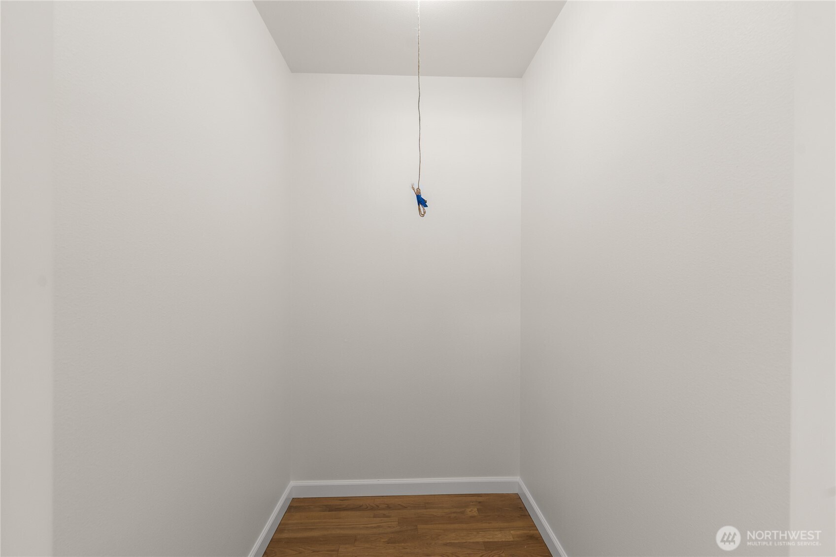 Spacious walk-in hallway closet providing ample storage for coats, linens, and household essentials