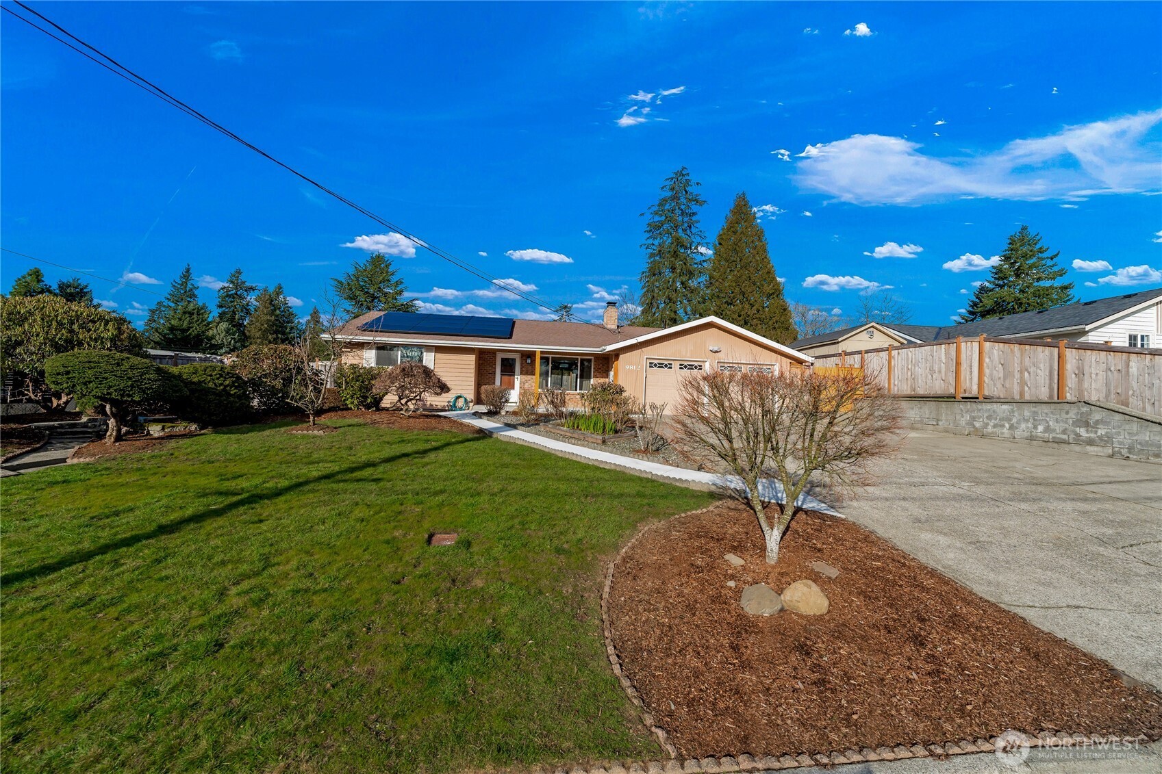 Large wide front yard with mature trees, offering great curb appeal in a peaceful residential setting