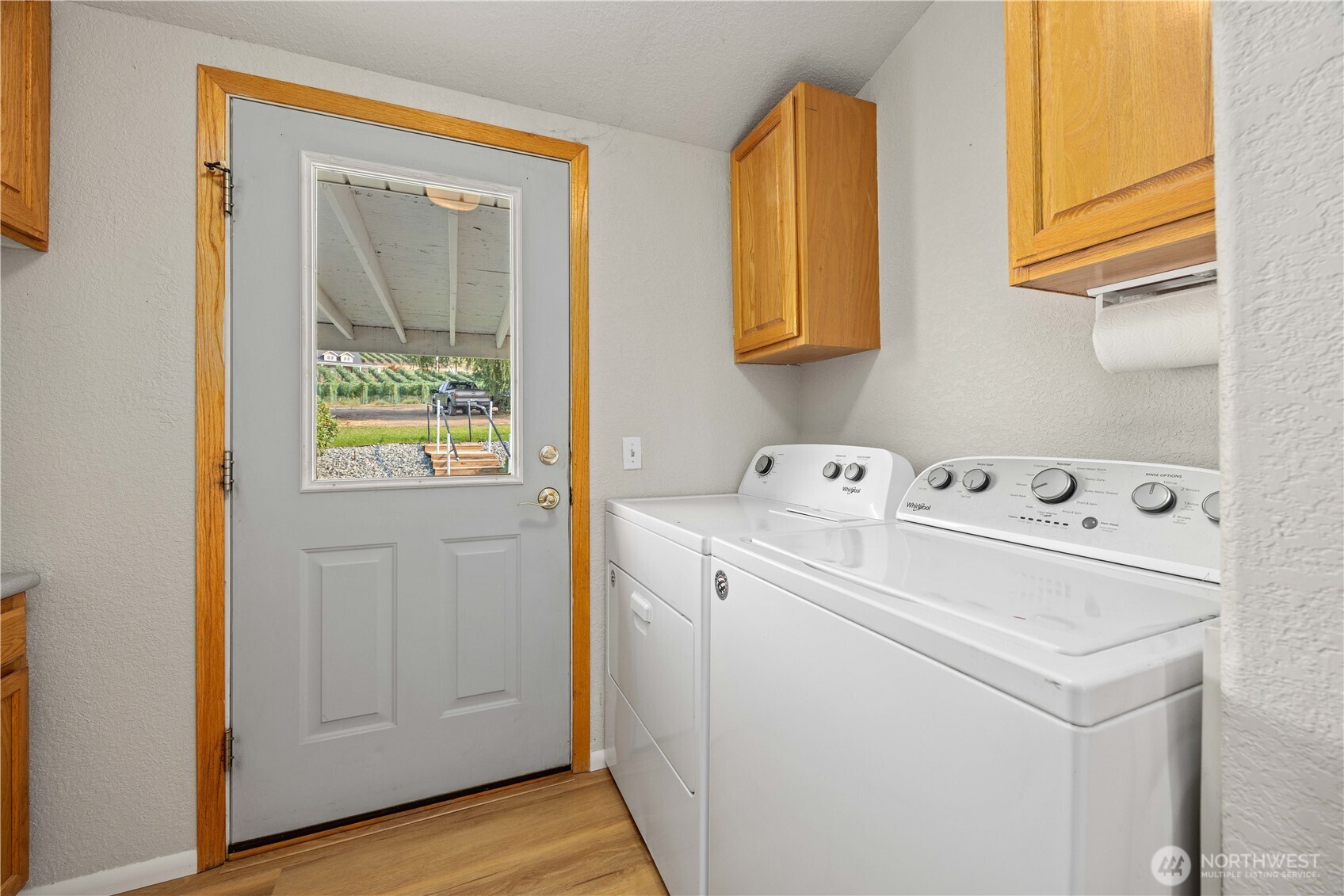 Laundry with door out to covered patio & garage