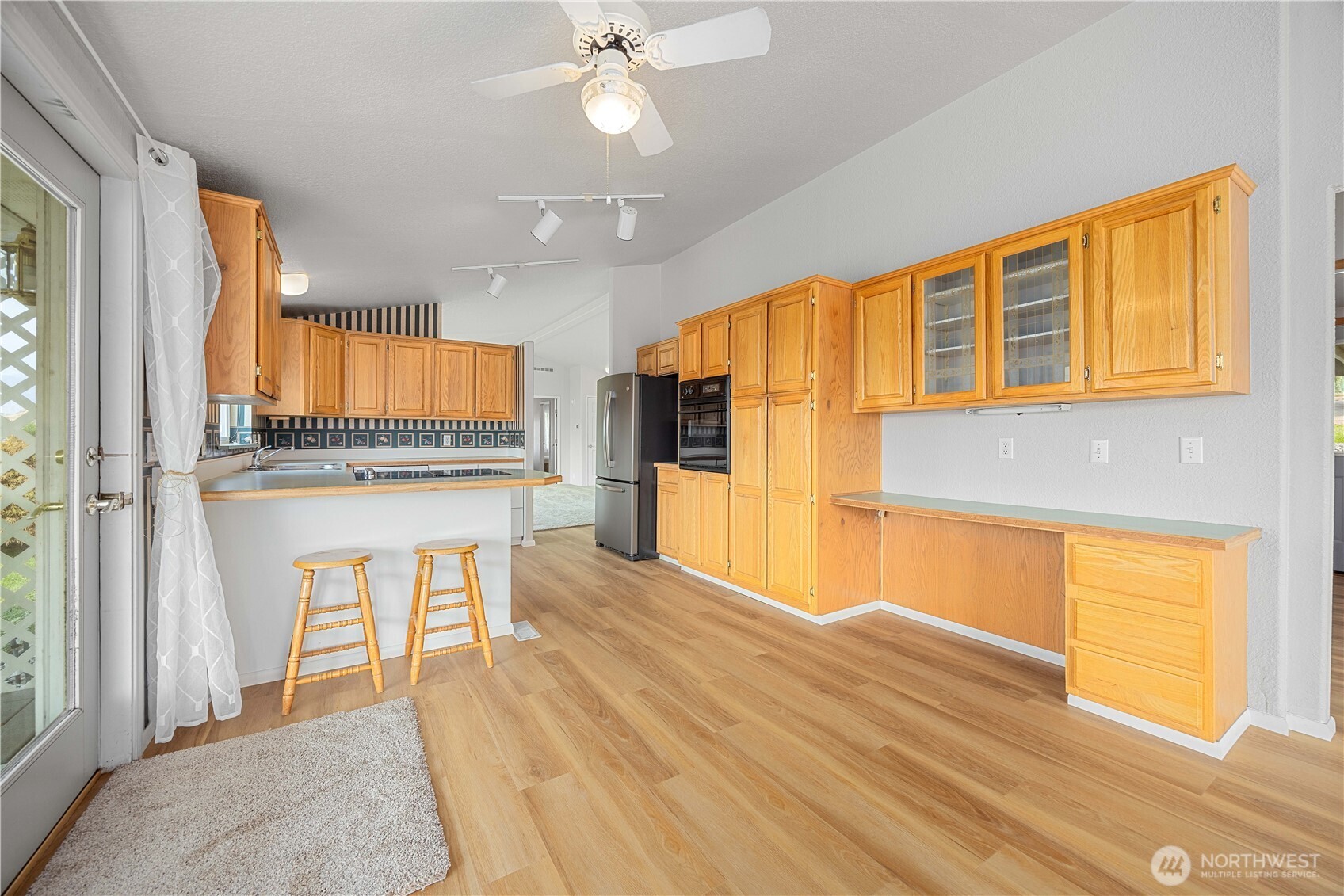 Kitchen with additional dining area and door to covered porch.