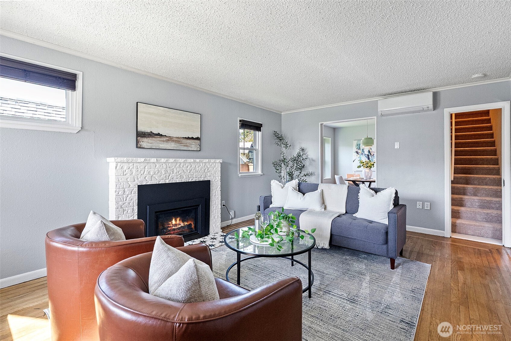 Enter into the welcoming living room which as both a new gas insert fireplace for warmth and coziness, as well as a mini split heating and cooling system.