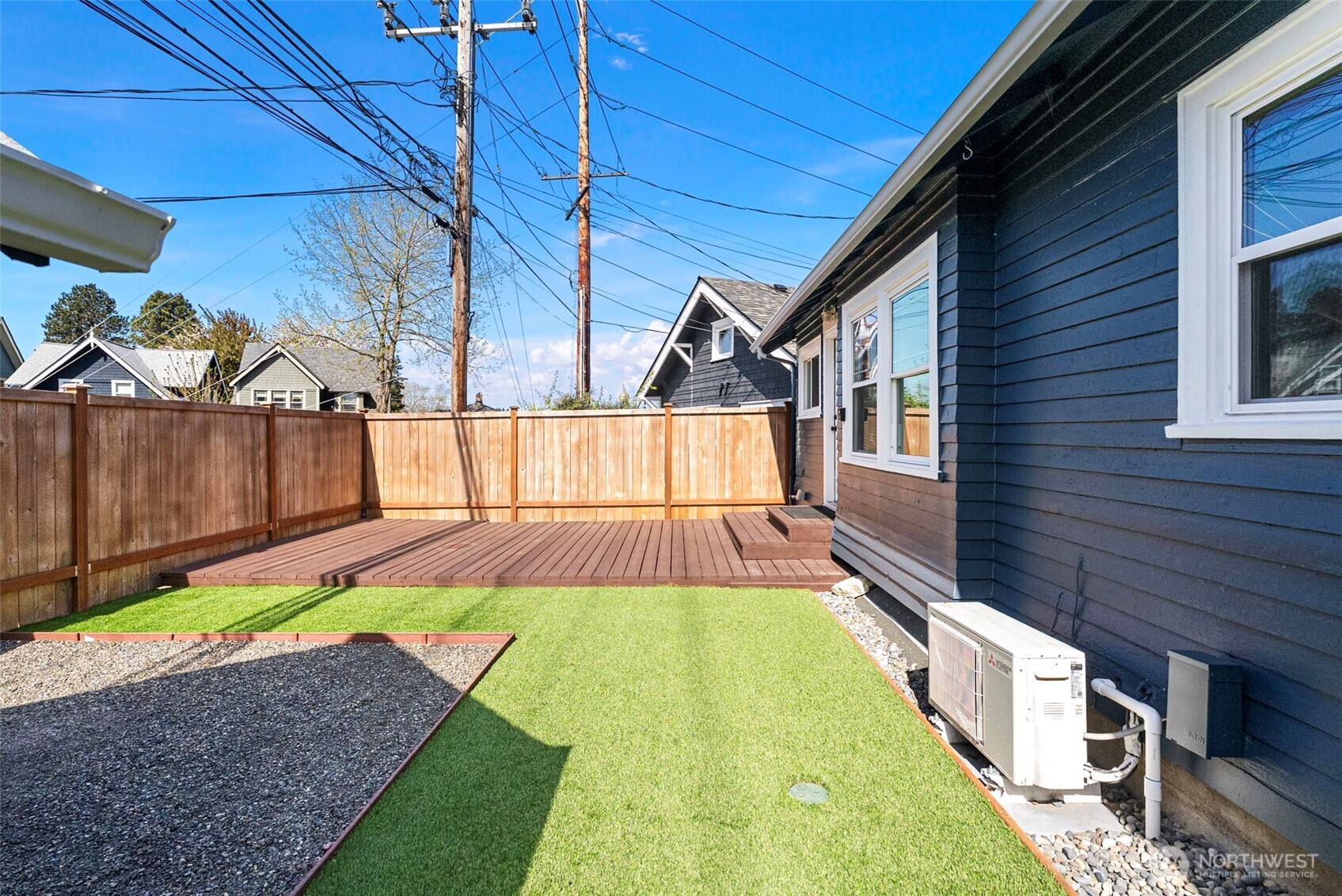 Private, fully fenced yard with low maintenance artificial turf.