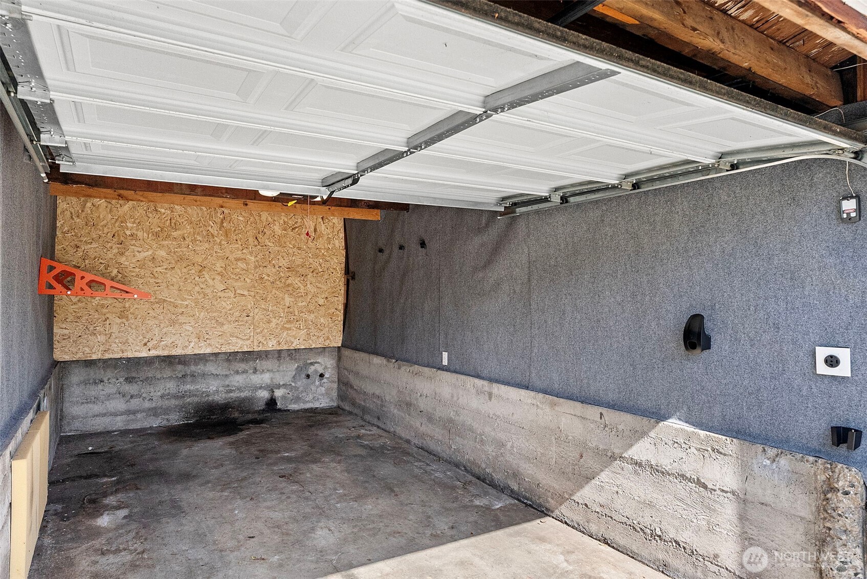 Garage fitted with electrical vehicle charging.