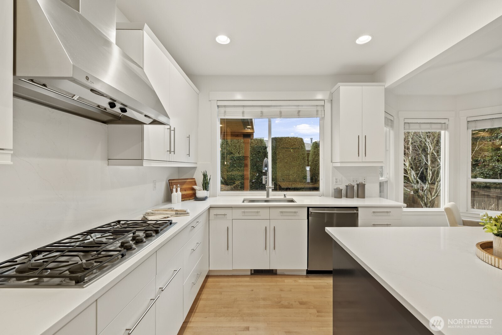 New quartz counters and solid maple cabinets sparkle in abundant natural light pouring in.